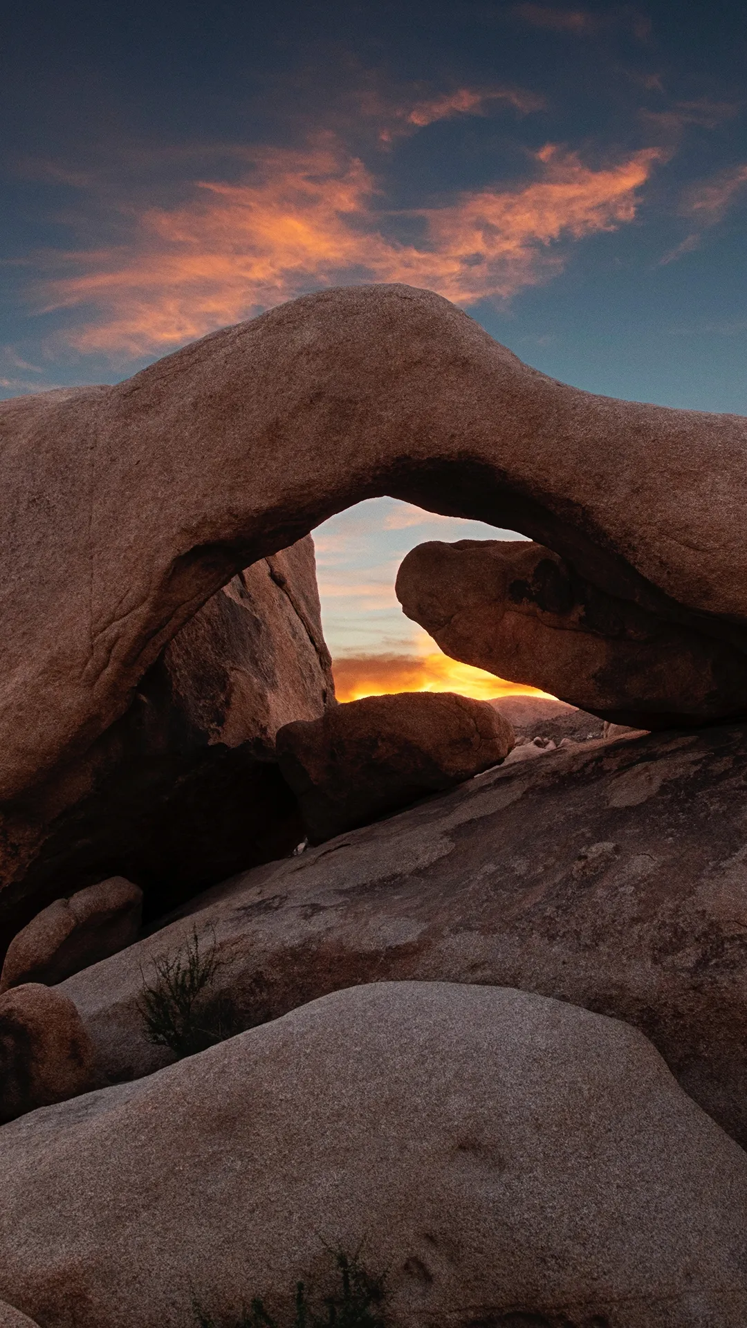 Natural Rock Arch Formation with Sunset Sky Background
