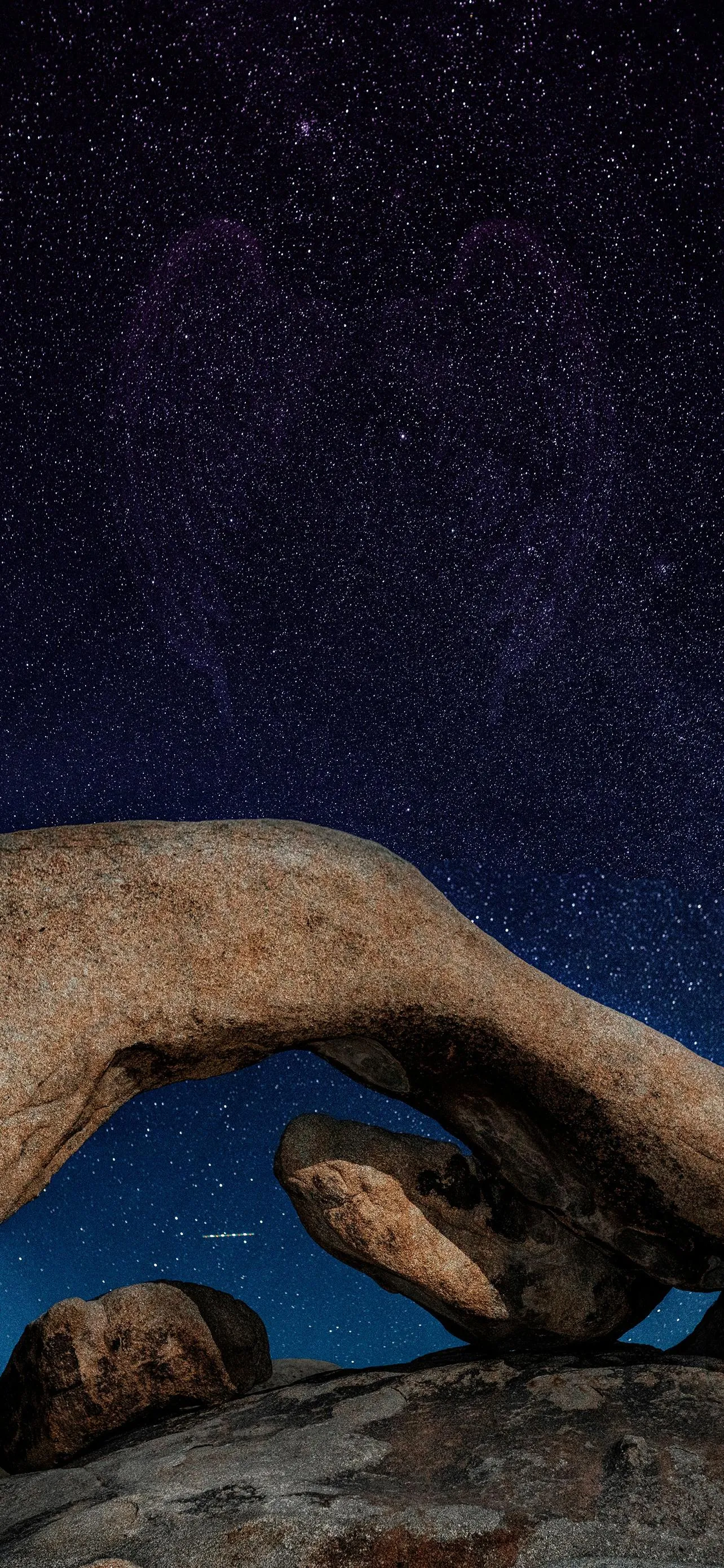Natural Stone Arch Framing a Sky Full of Bright Stars