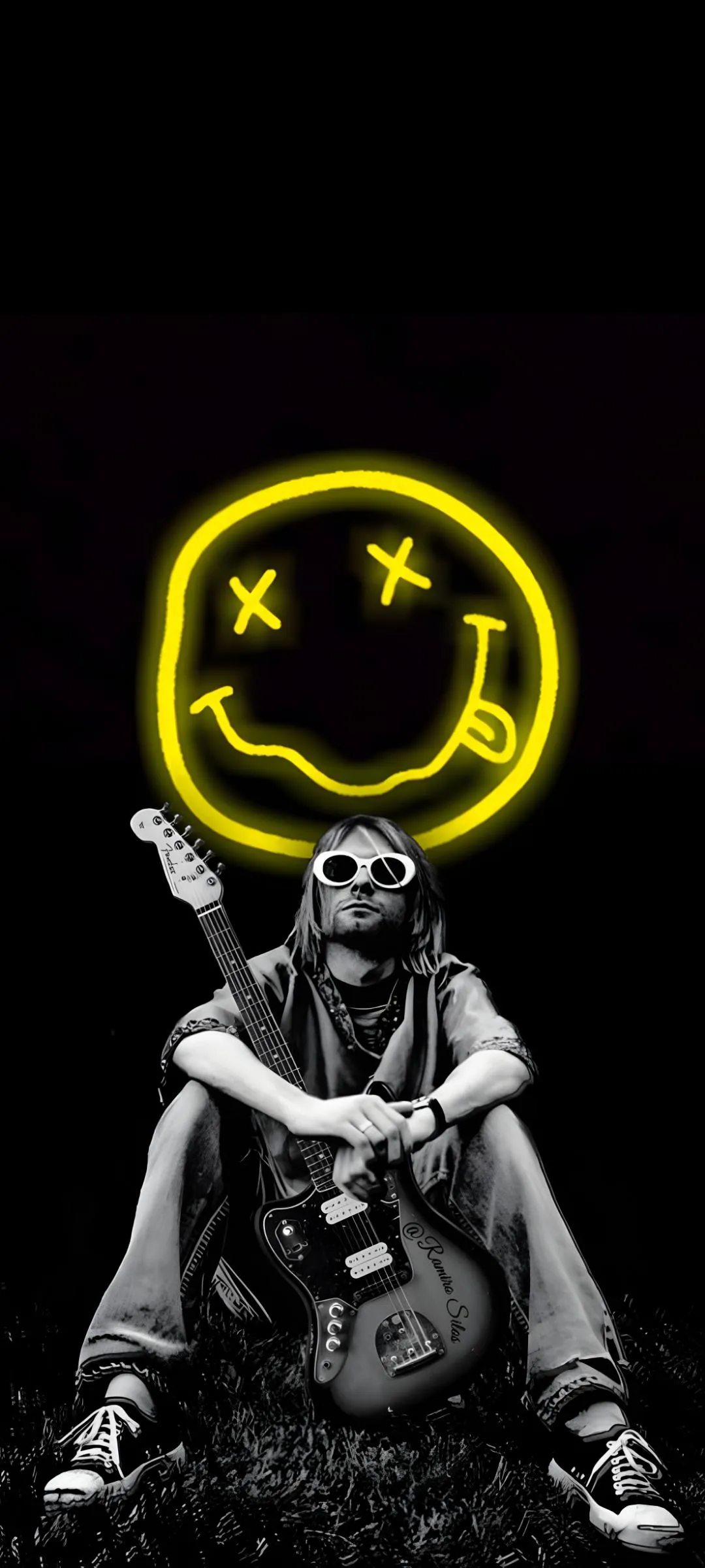 Neon Emoji Face Sign Rock Design with Man On Black Backdrop