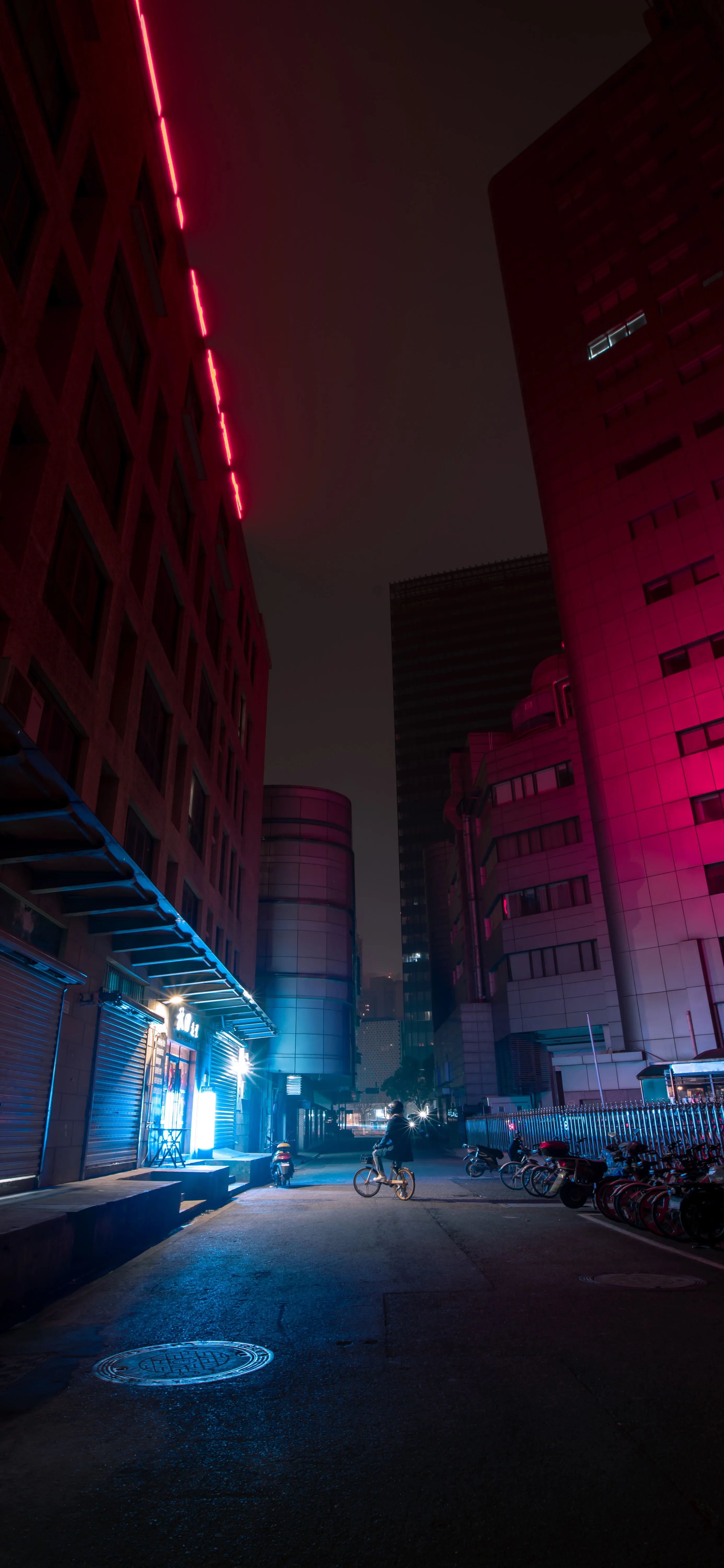 Neon Lit Urban Alley with Red and Blue Lights at Night