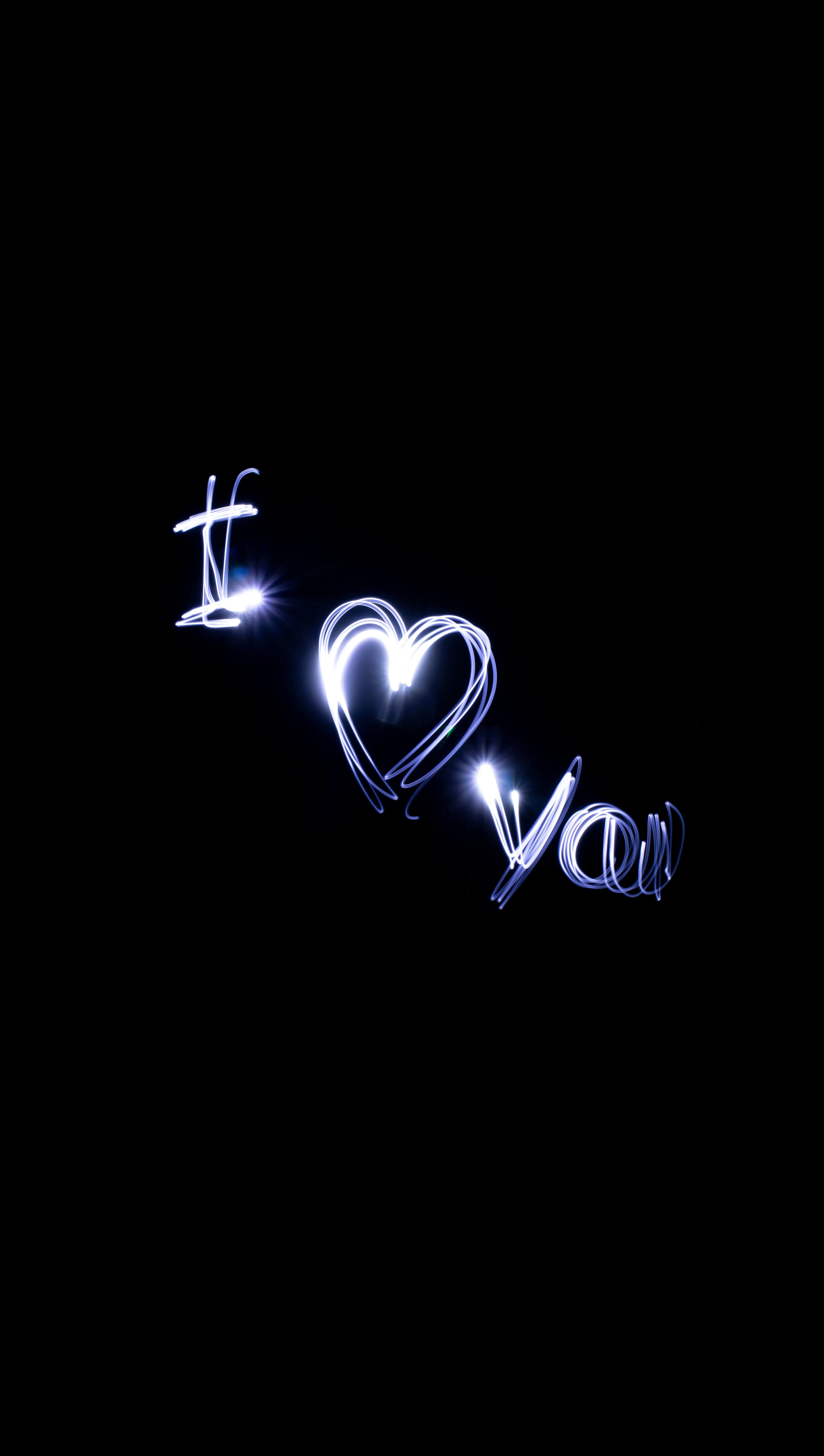 Neon Love Text Glowing Bright Against Black Background