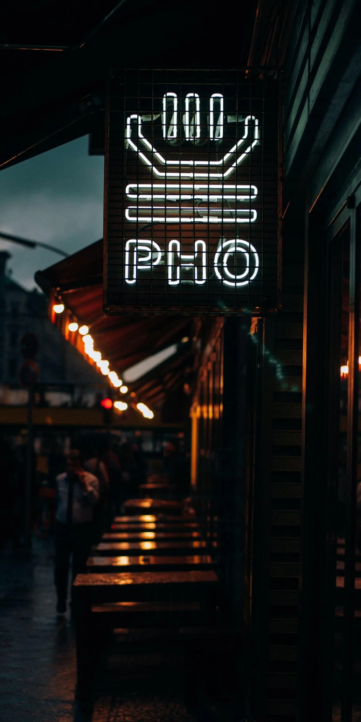 Neon Vietnamese Signboard Glowing in Night Alleyway