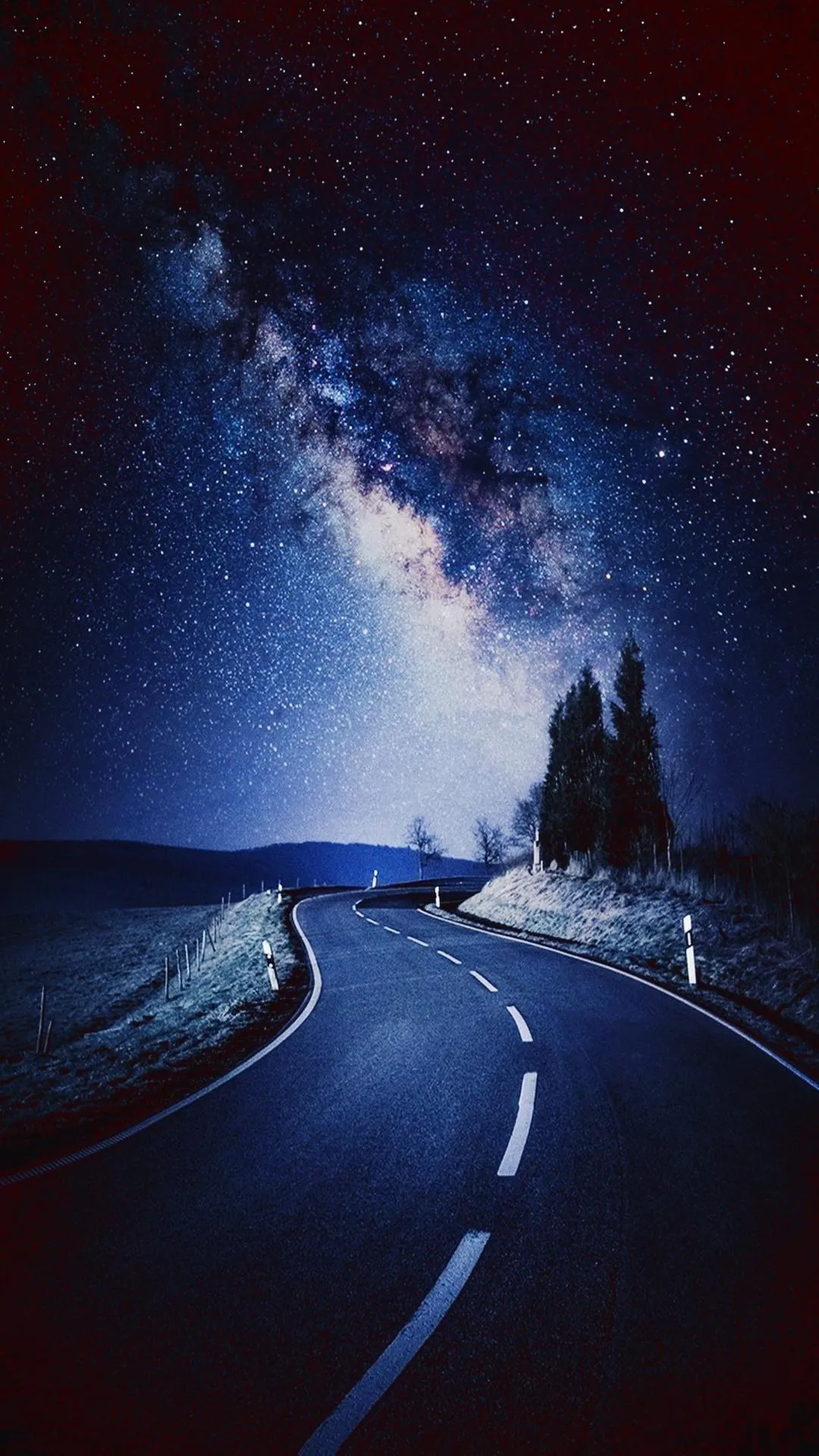 Night Road with Glowing Lights and Distant Tree Line