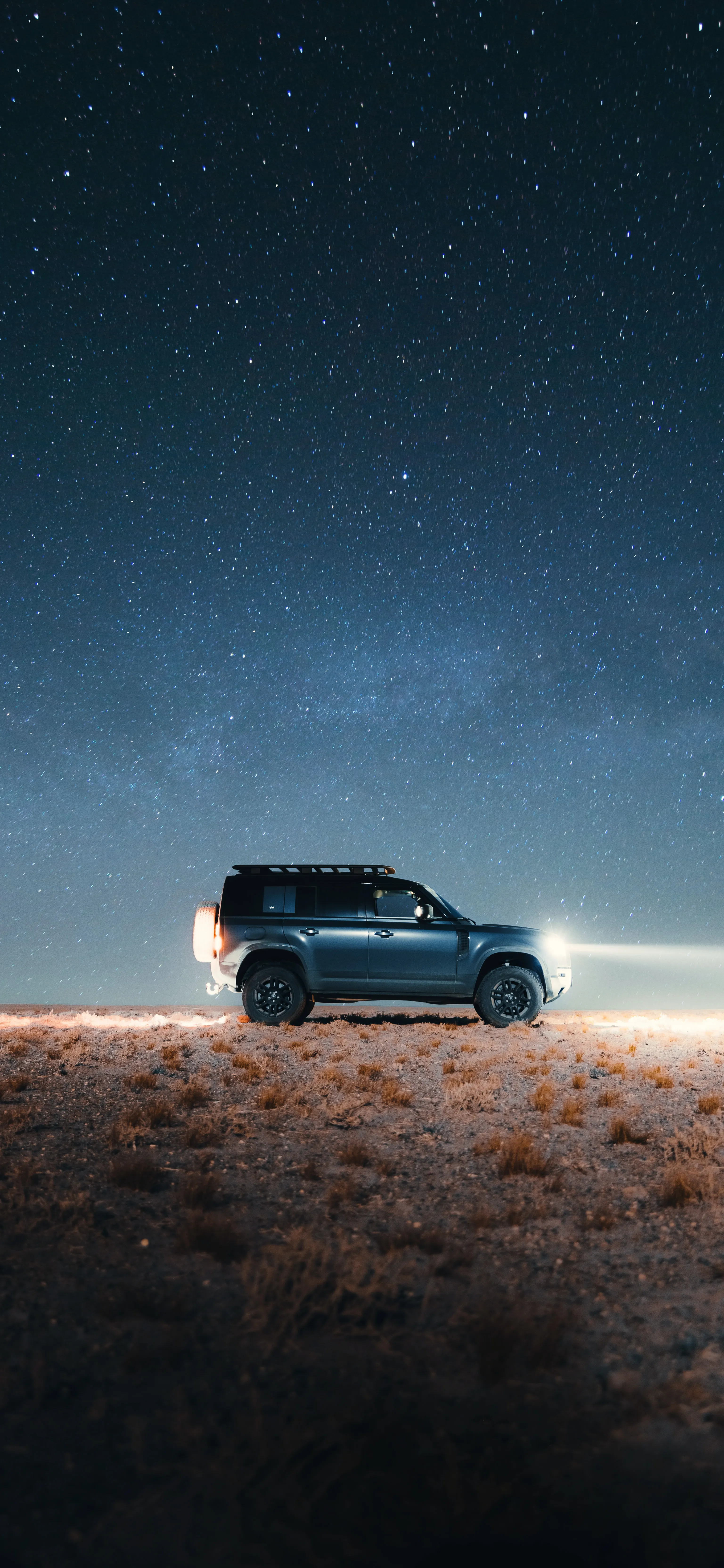 Night Scene with Car Parked Under a Starry Sky Wallpaper