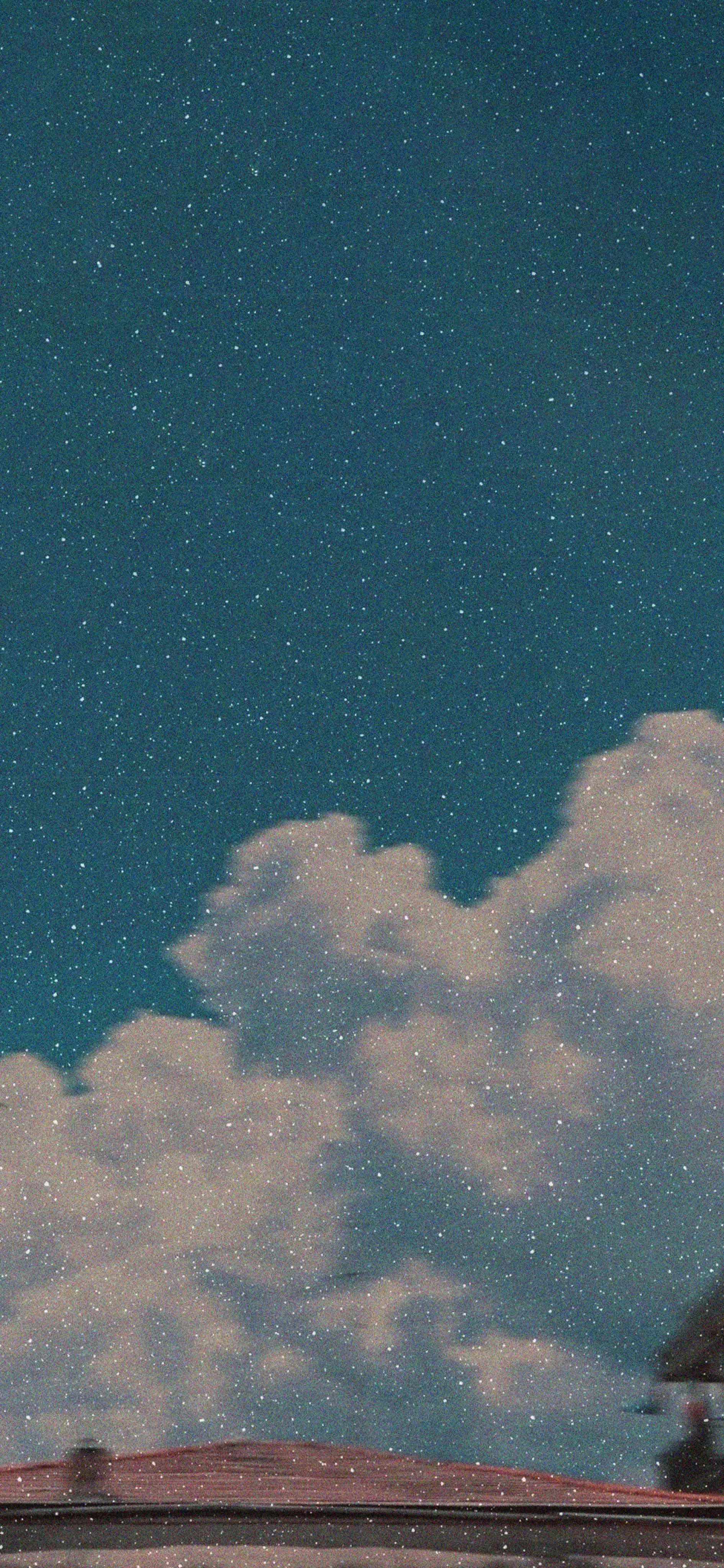 Night Sky Filled with Clouds Under Starlit Atmosphere