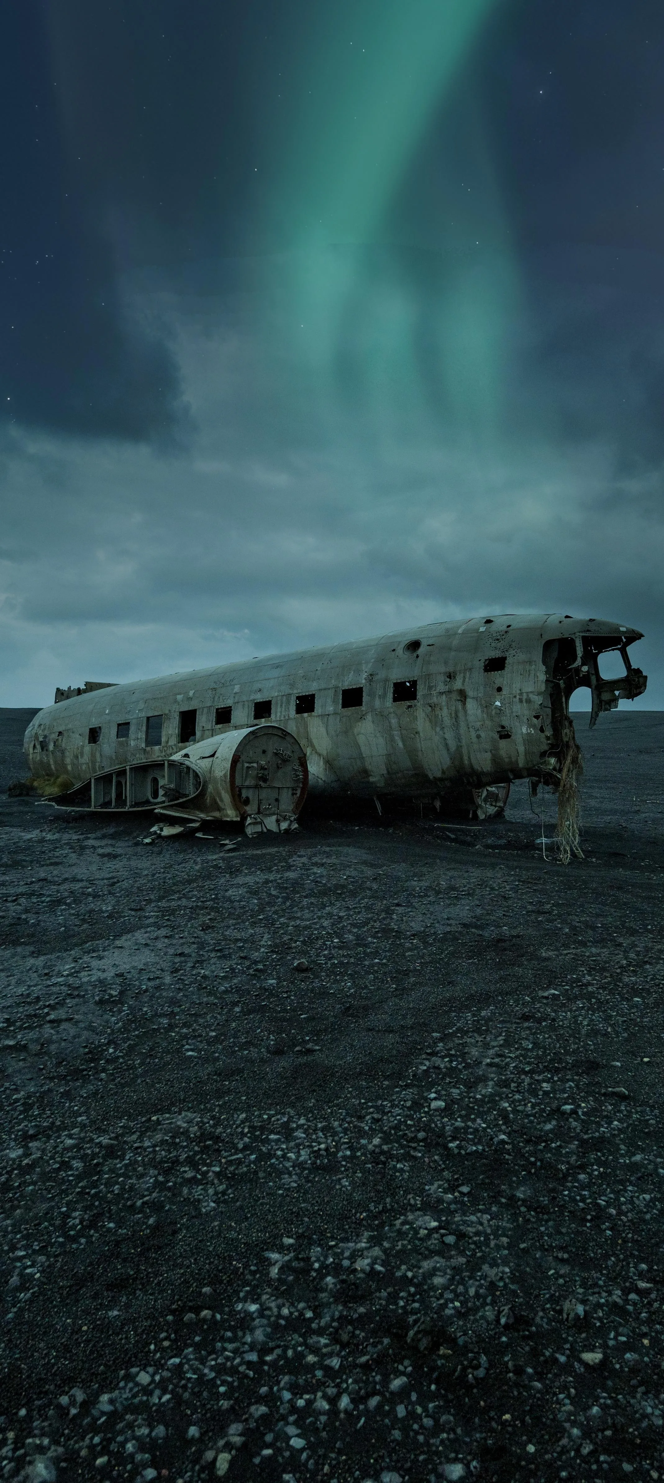 Northern Lights Over Dark Mountains and Abandoned Cabin