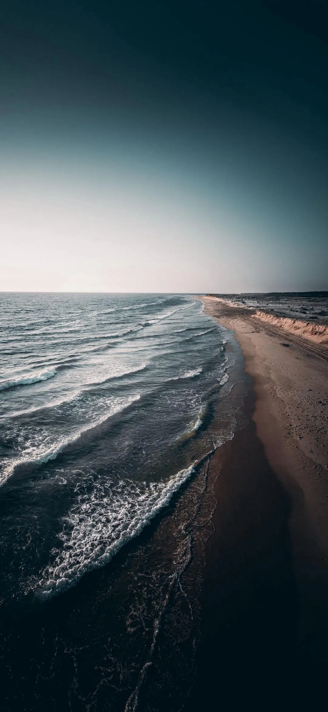 Ocean Wave Crashing on the Beach at Sunrise Wallpaper
