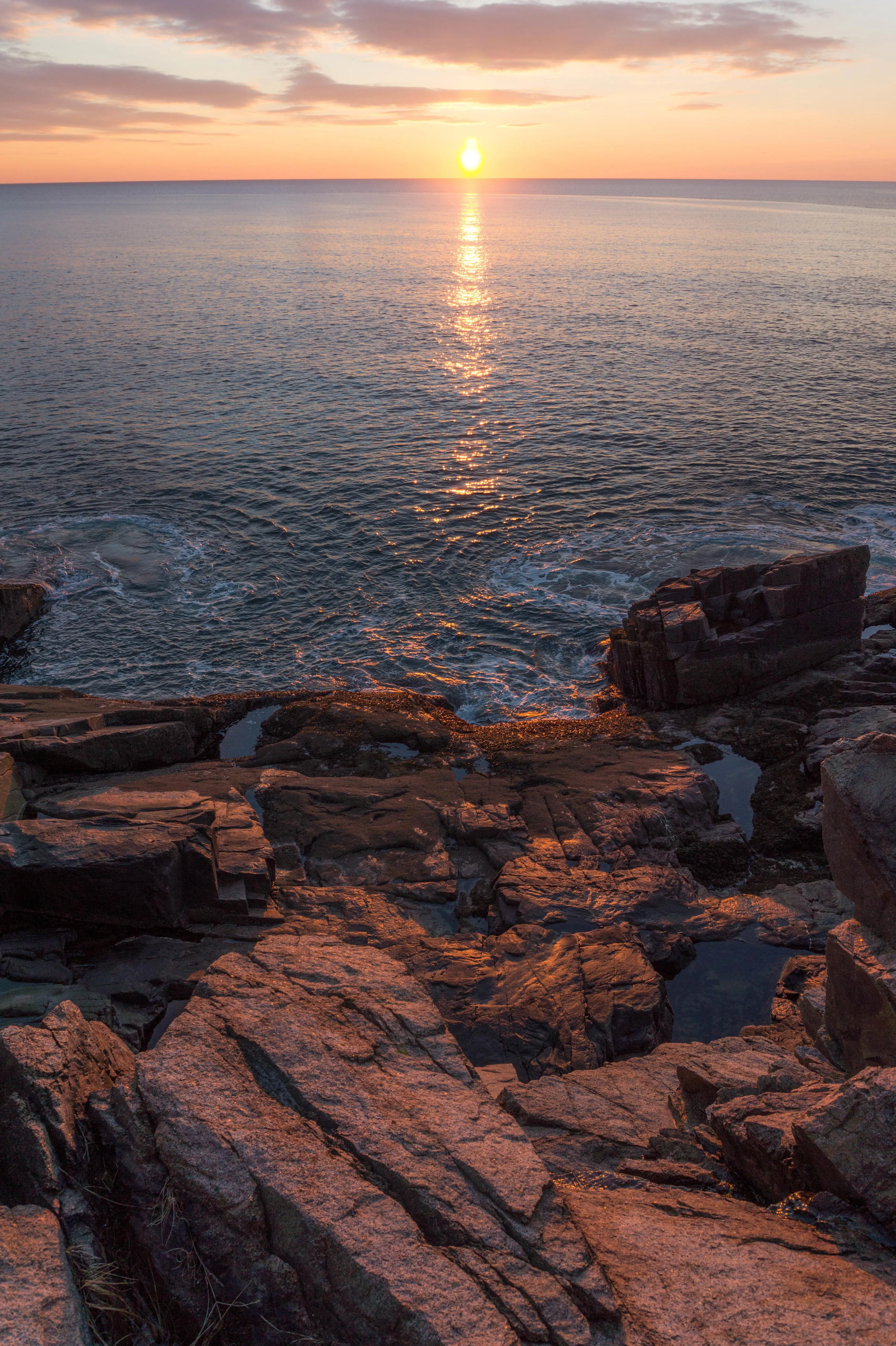 Ocean Waves Crashing at Sunset with Rocky Coastline