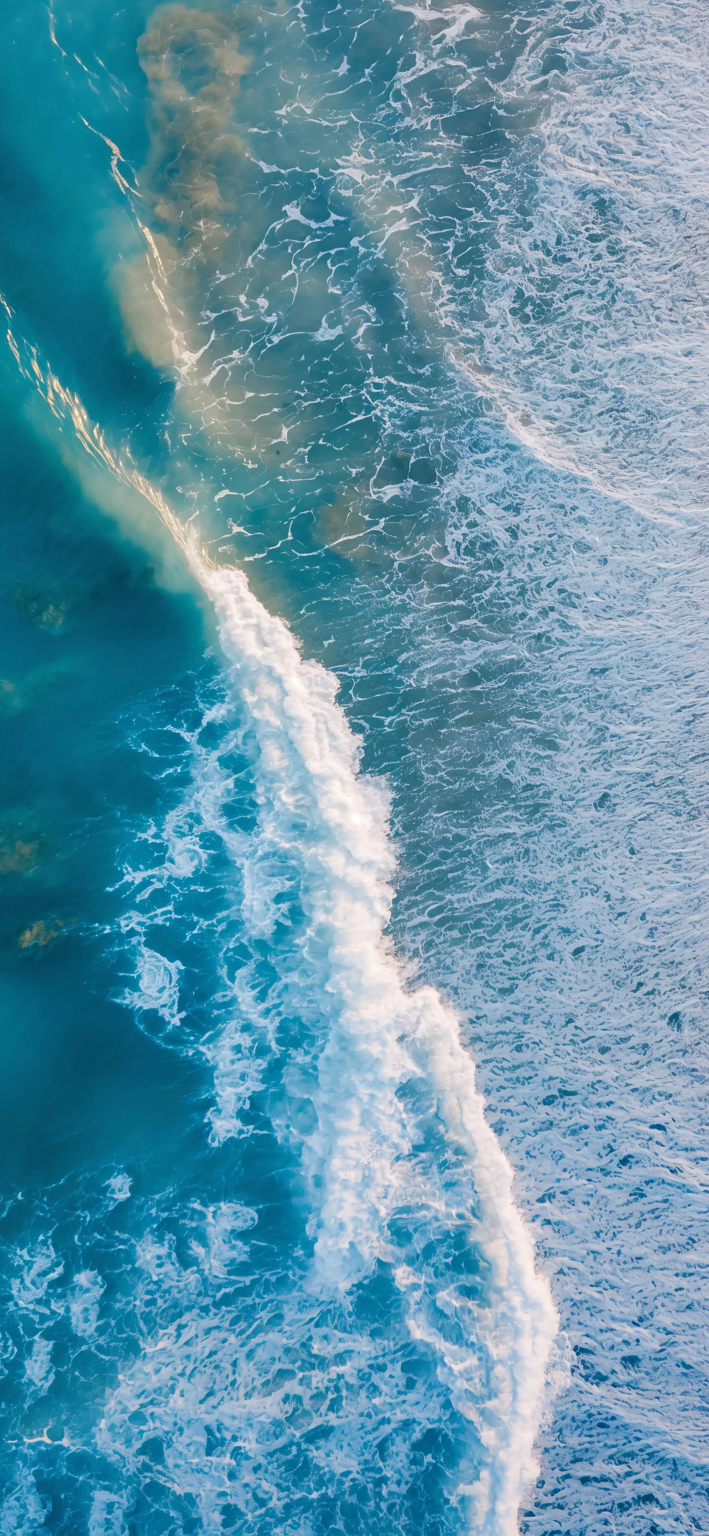 Ocean Waves Crashing Gently Along The Remote Coastline