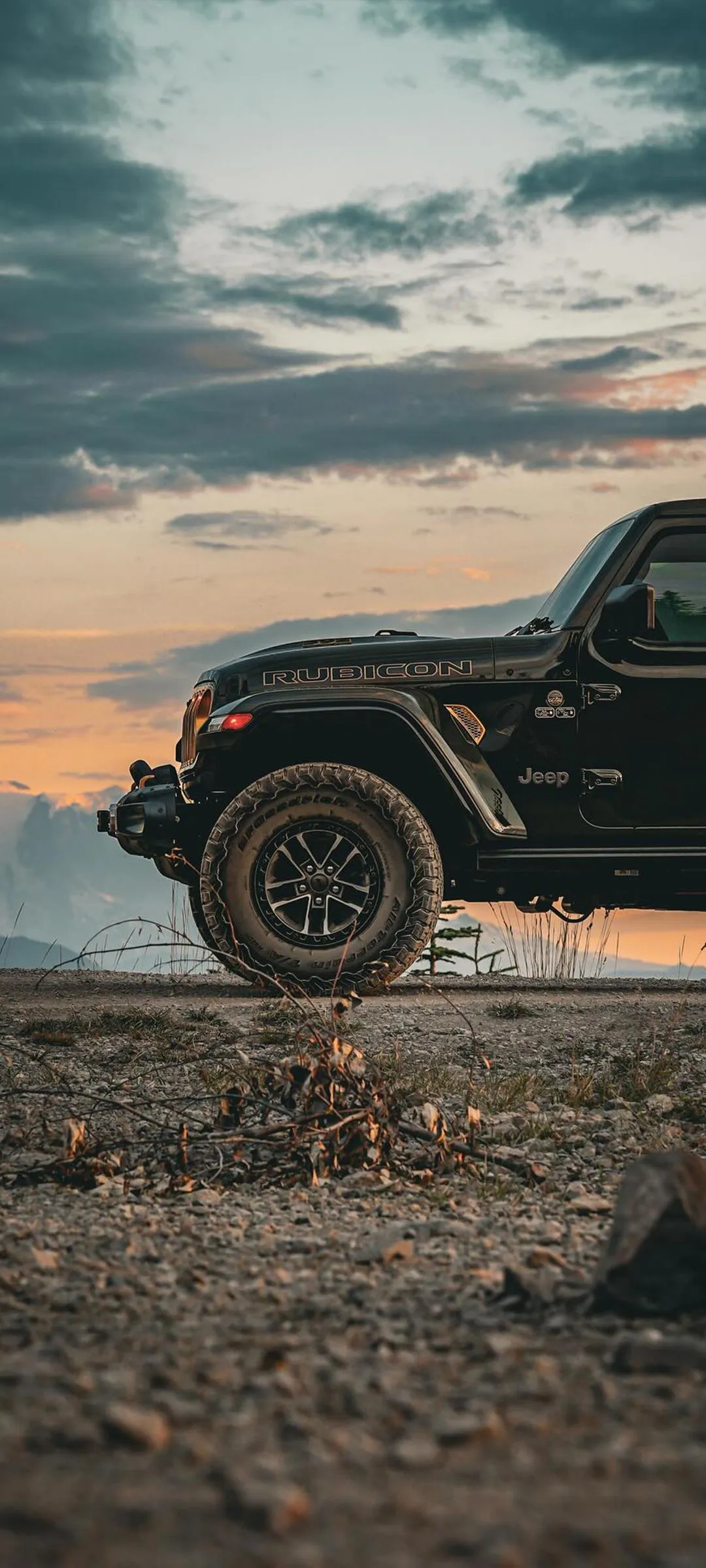 Offroad SUV at Sunset on Rocky Terrain with Scenic Sky
