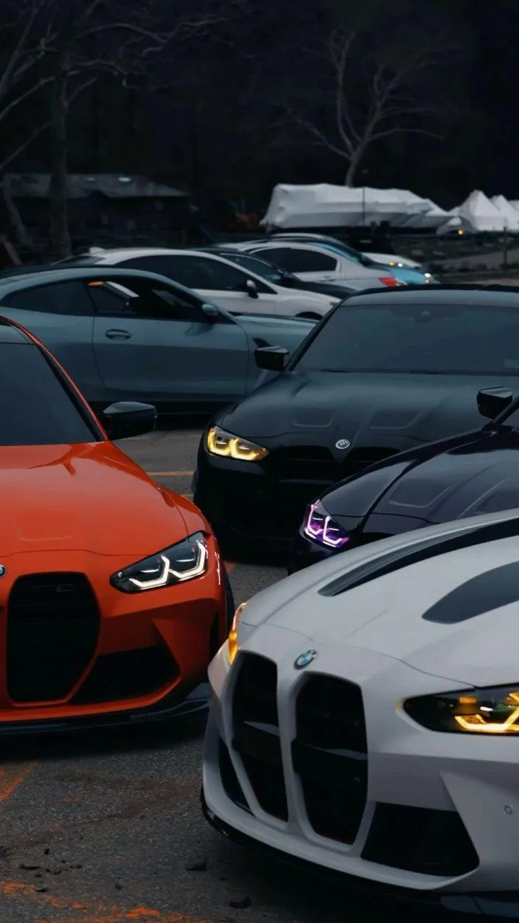 Orange and White Sports Cars in Parking Lot Wallpaper