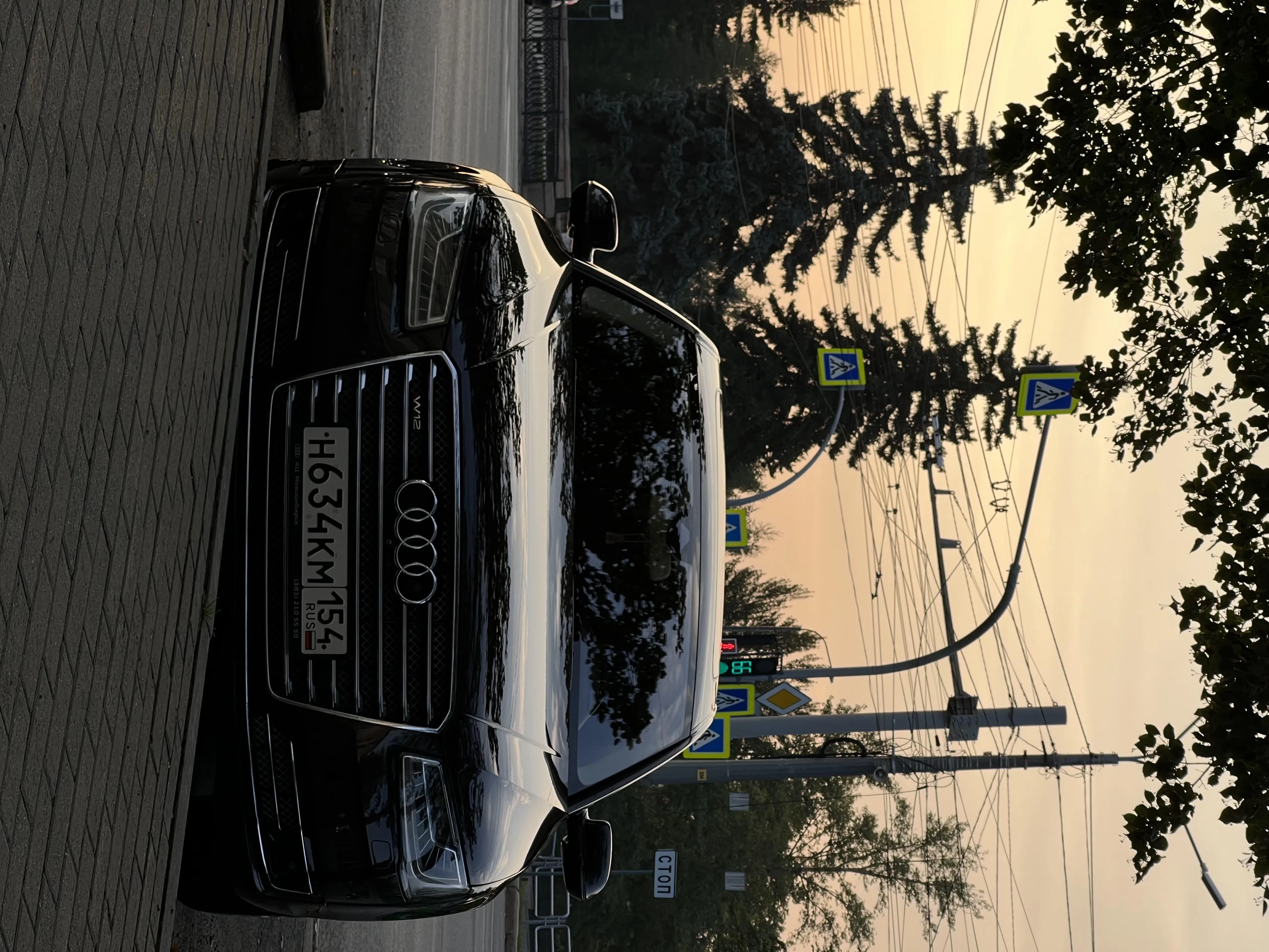 Parked Black Car During Sunset on City Street Image