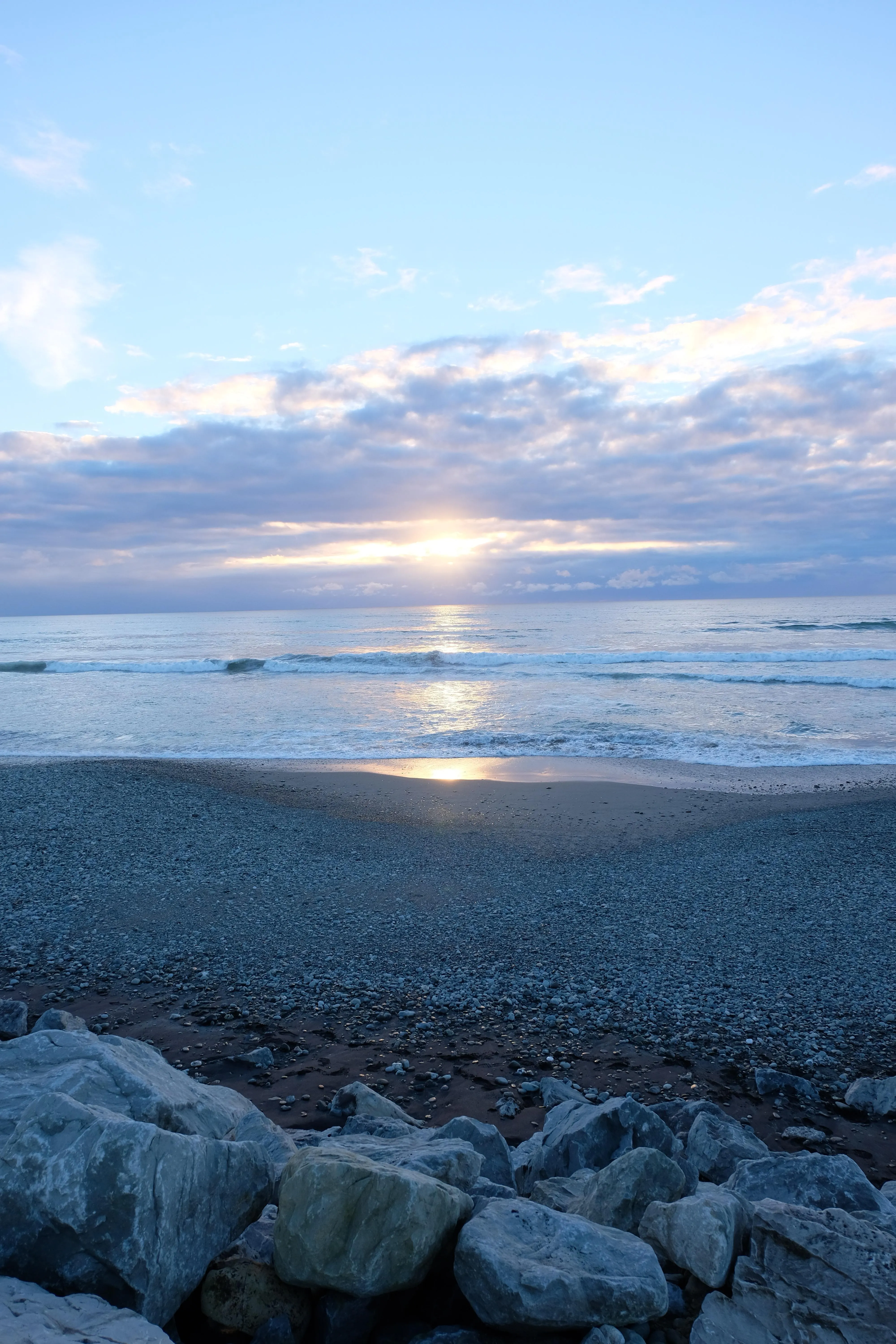 Peaceful Beach Scene with Rocks and Calm Ocean Water