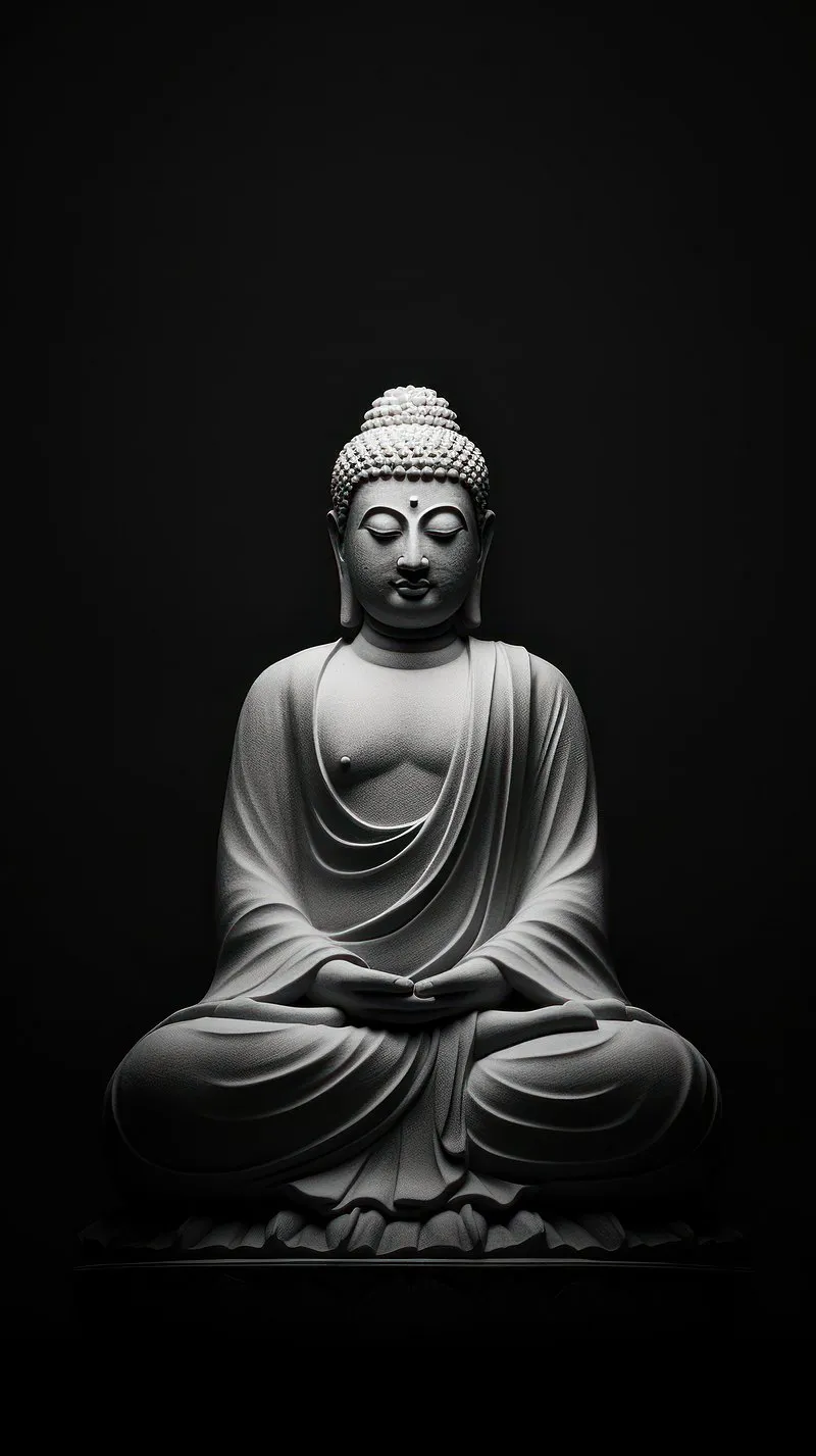Peaceful Buddha Statue Sitting in Calm Meditation Wallpaper