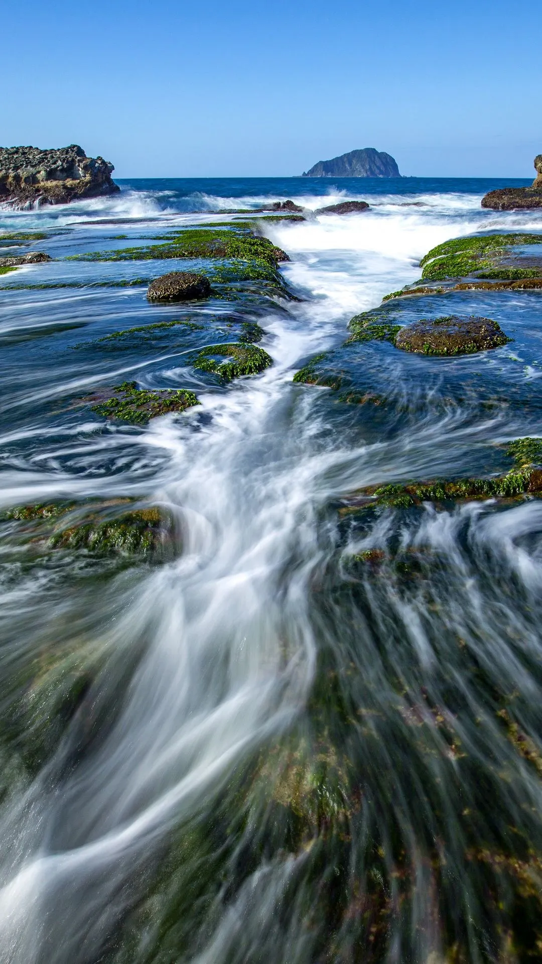 Peaceful Flowing River among Rocks in Bright Daylight Scene