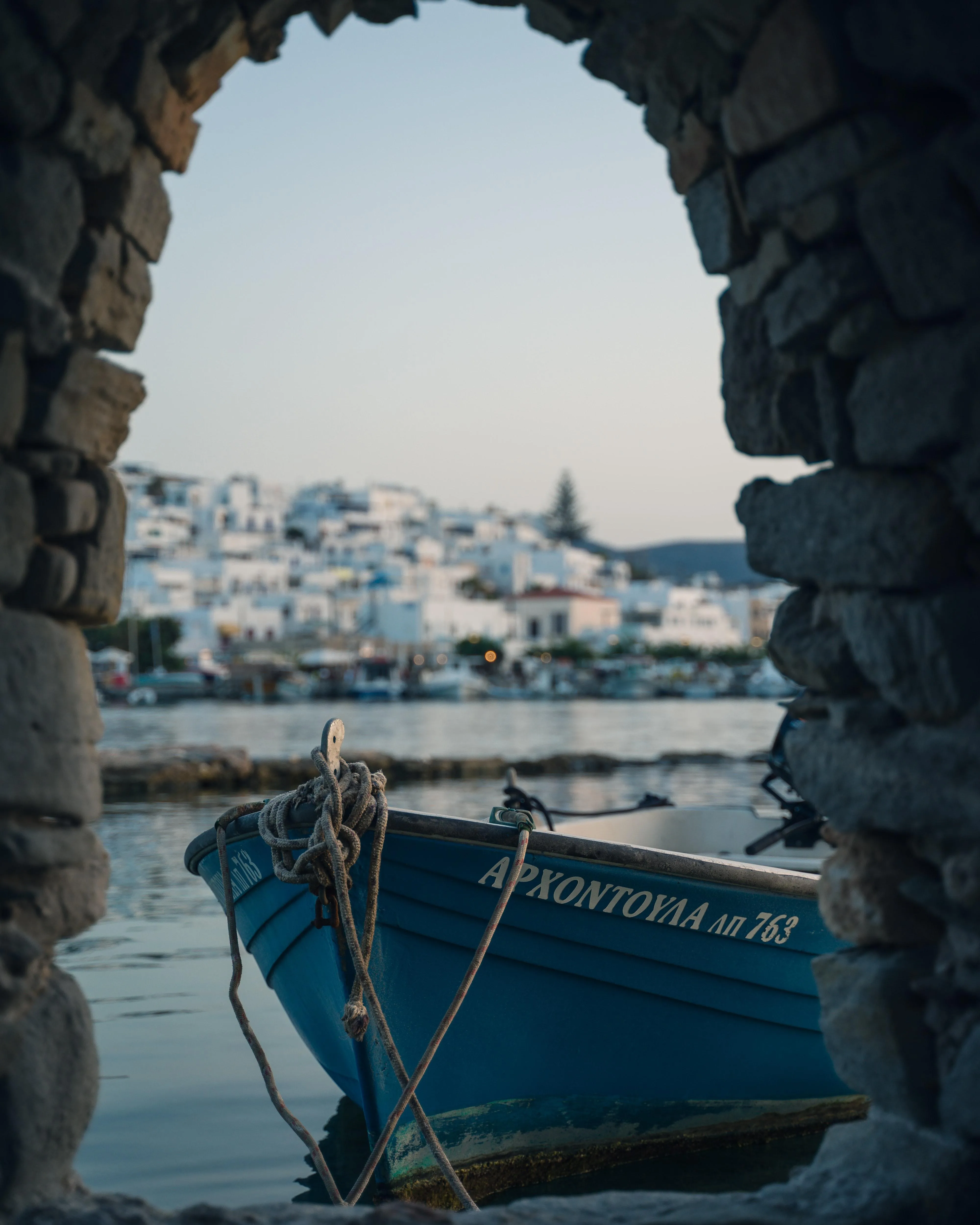 Peaceful Harbor View Framed by Stone Arch and Blue Water