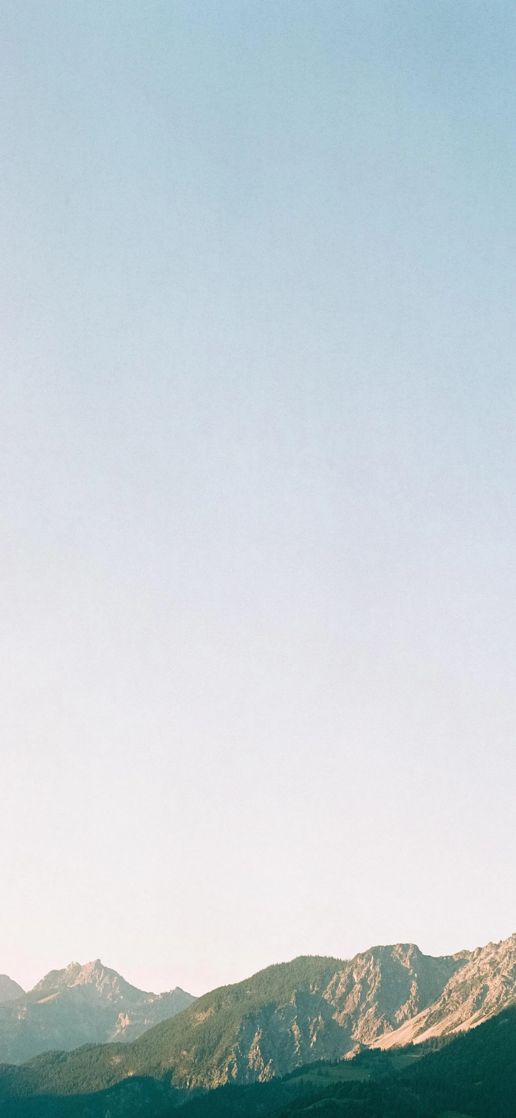 Peaceful Mountain Landscape Under Clear Blue Sky Wallpaper