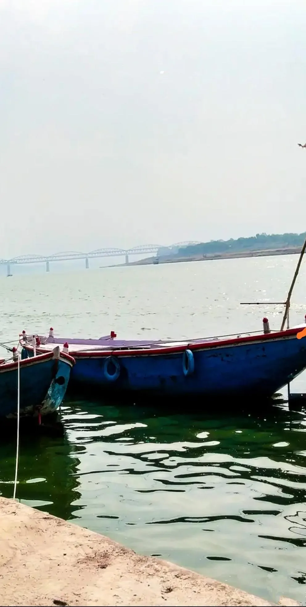 Peaceful Seaside View with Boat and Calm Water Sky Wallpaper