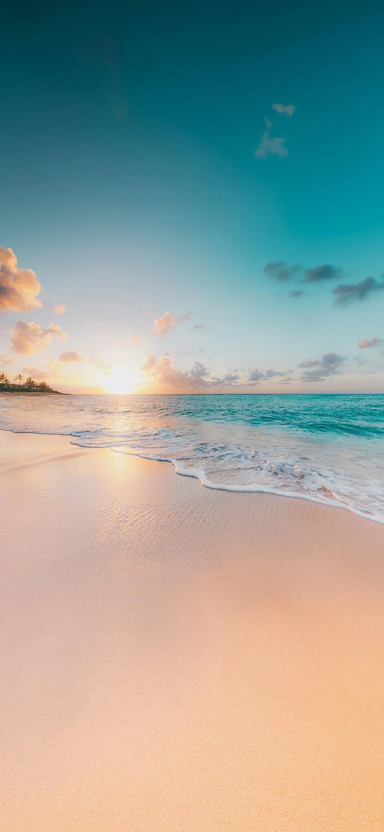 Peaceful Sunset on a Beach with Soft Ocean Waves Wallpaper