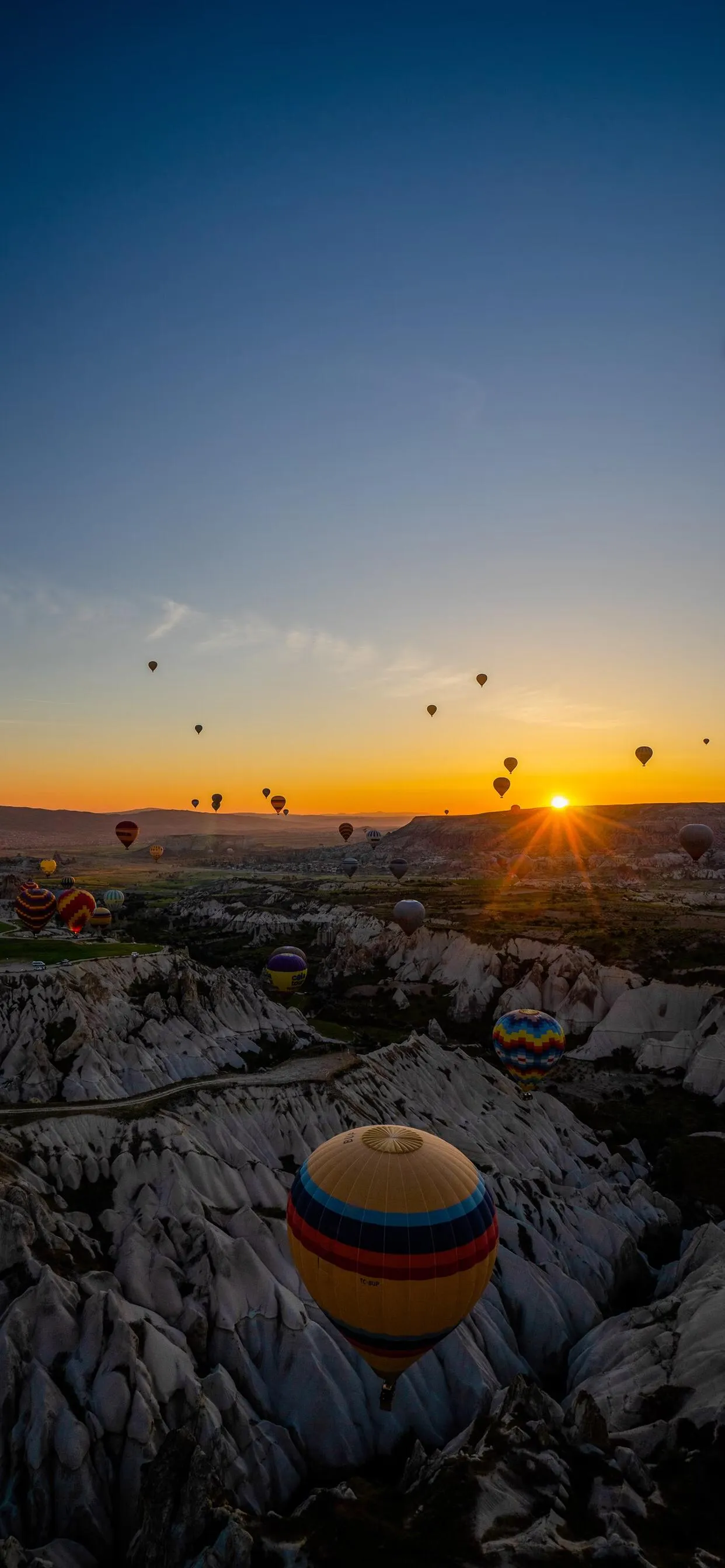 Peaceful Sunset Over the Ocean with Rocks and Sand