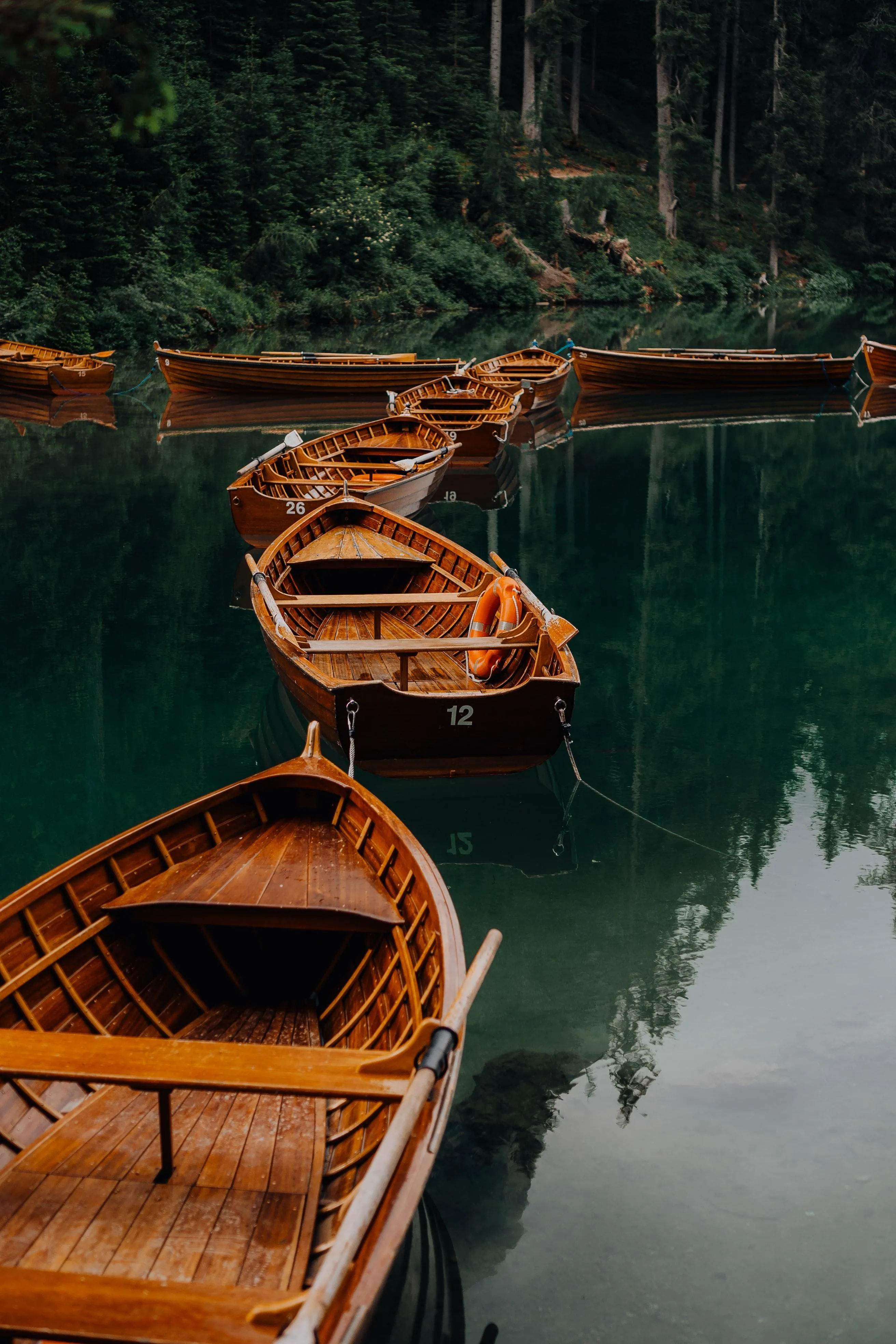 Peaceful Wooden Boats Floating on Calm Reflective Water