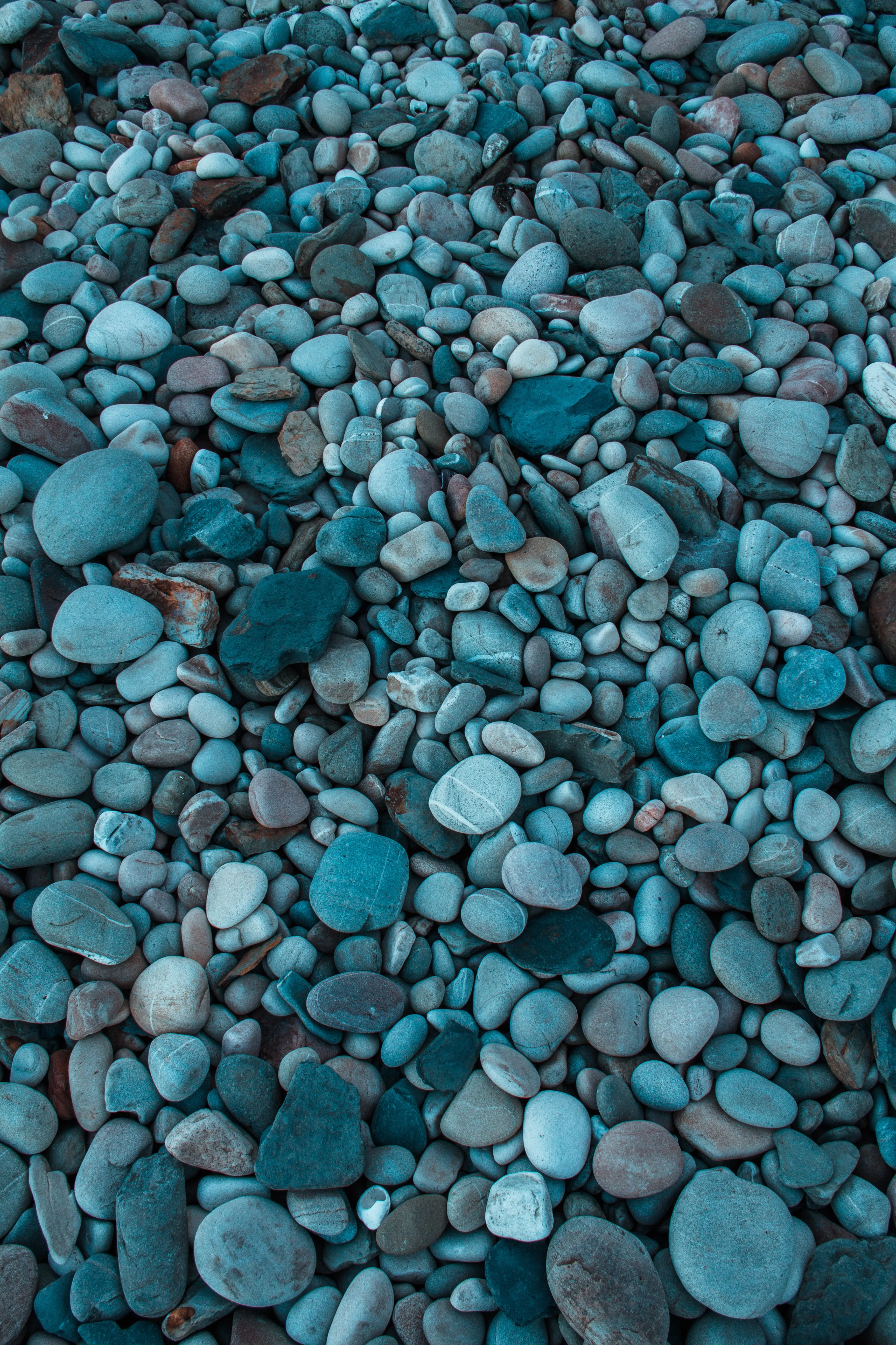 Pebble Beach with Blue Stones Near Clear Water Wallpaper