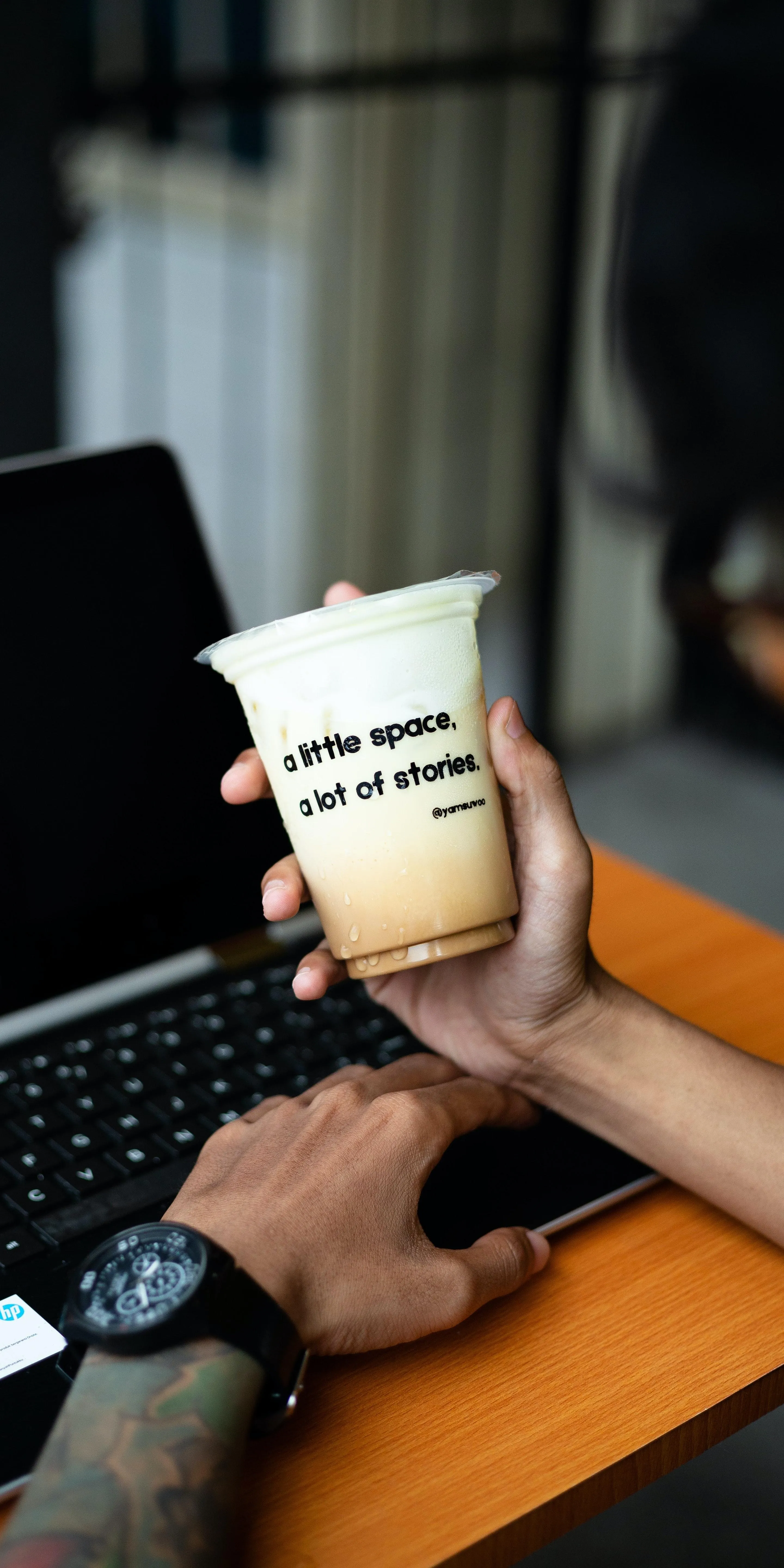 Person Holding Coffee Cup While Working on Laptop Image