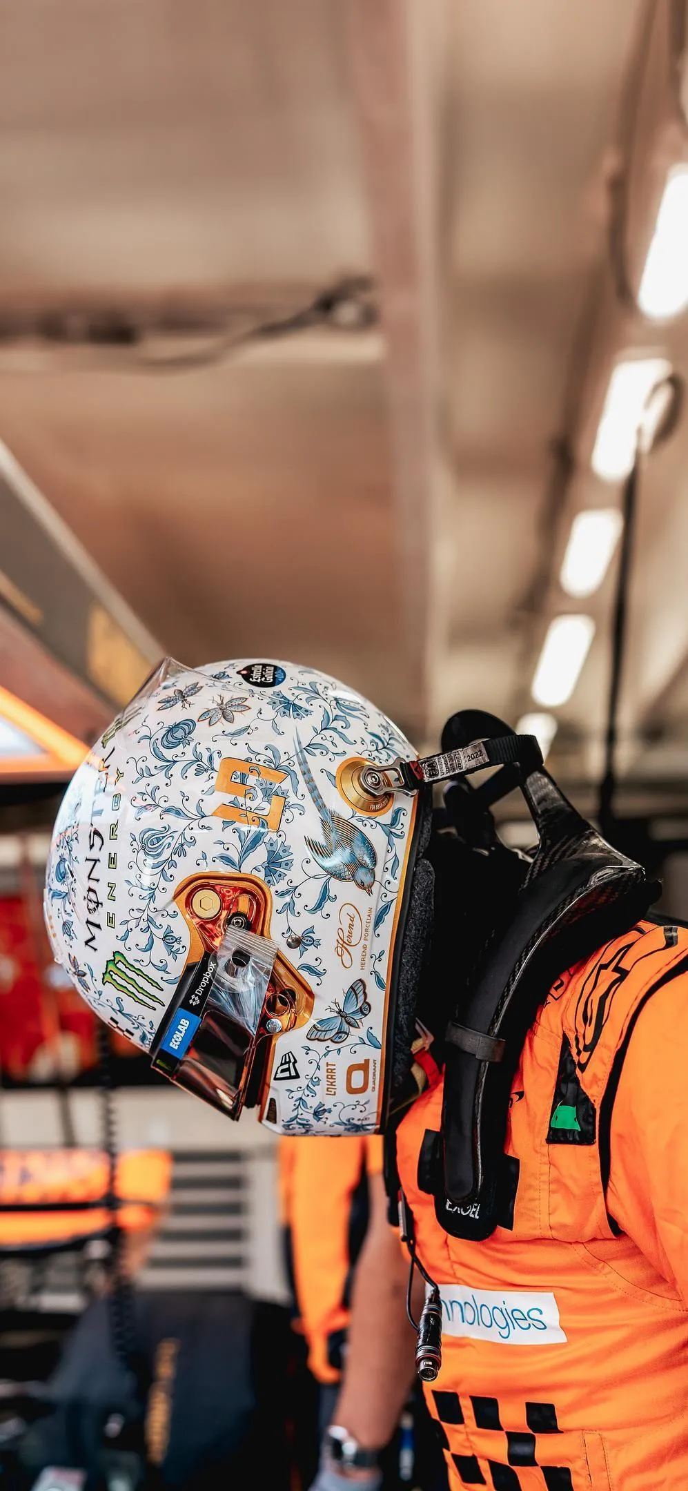 Person in Orange Suit Walking Through Art Gallery Space