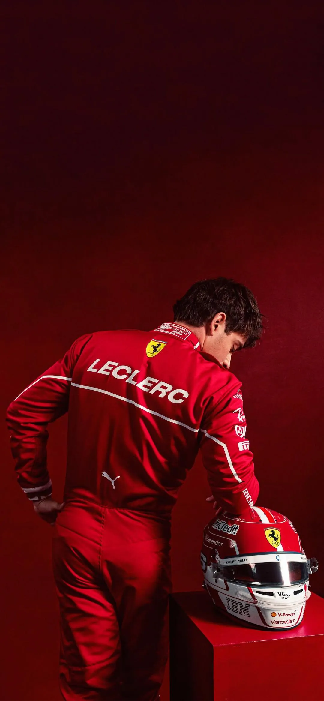 Person in Red Racing Suit Holding White Helmet Wallpaper