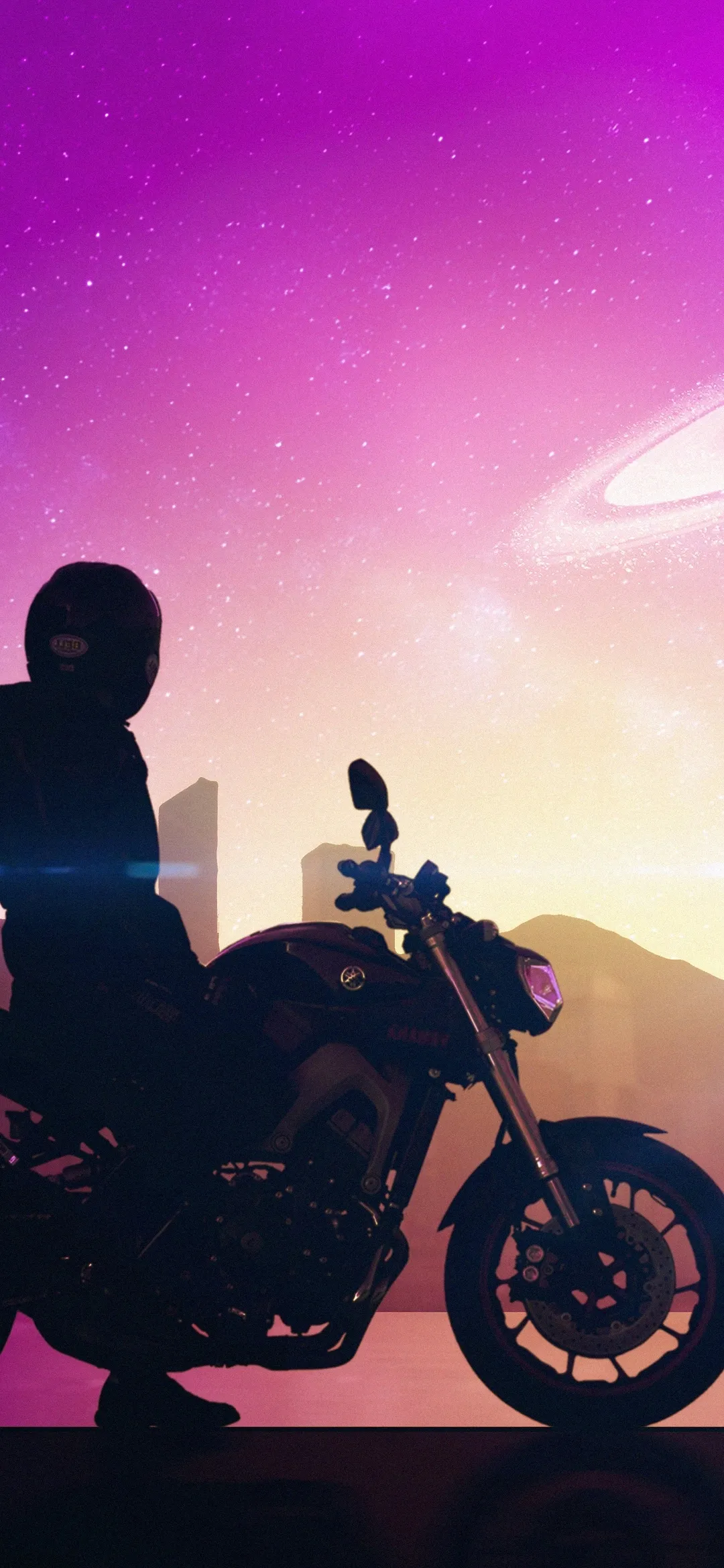 Person Sitting on Motorcycle Under a Pink and Purple Sky