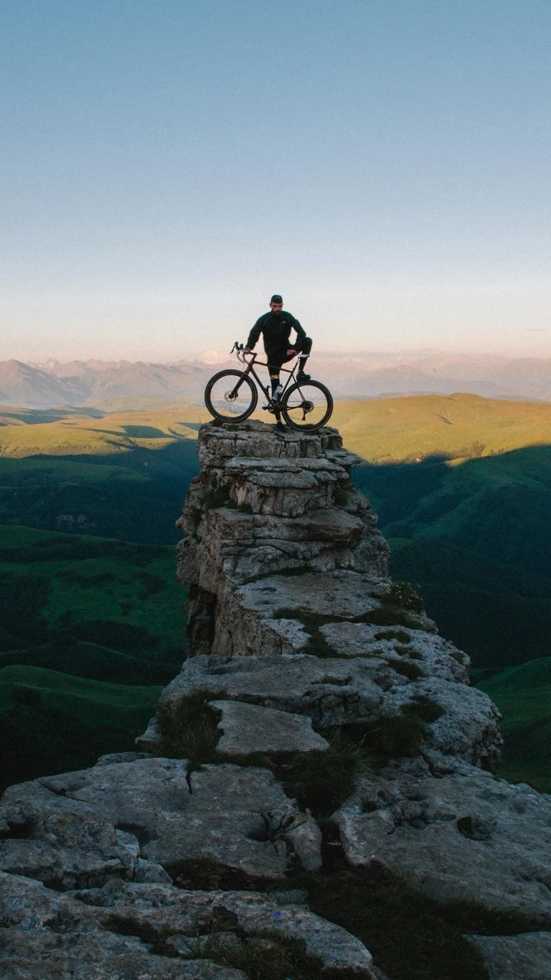 Person Standing On Rocky Path Overlooking Mountain View