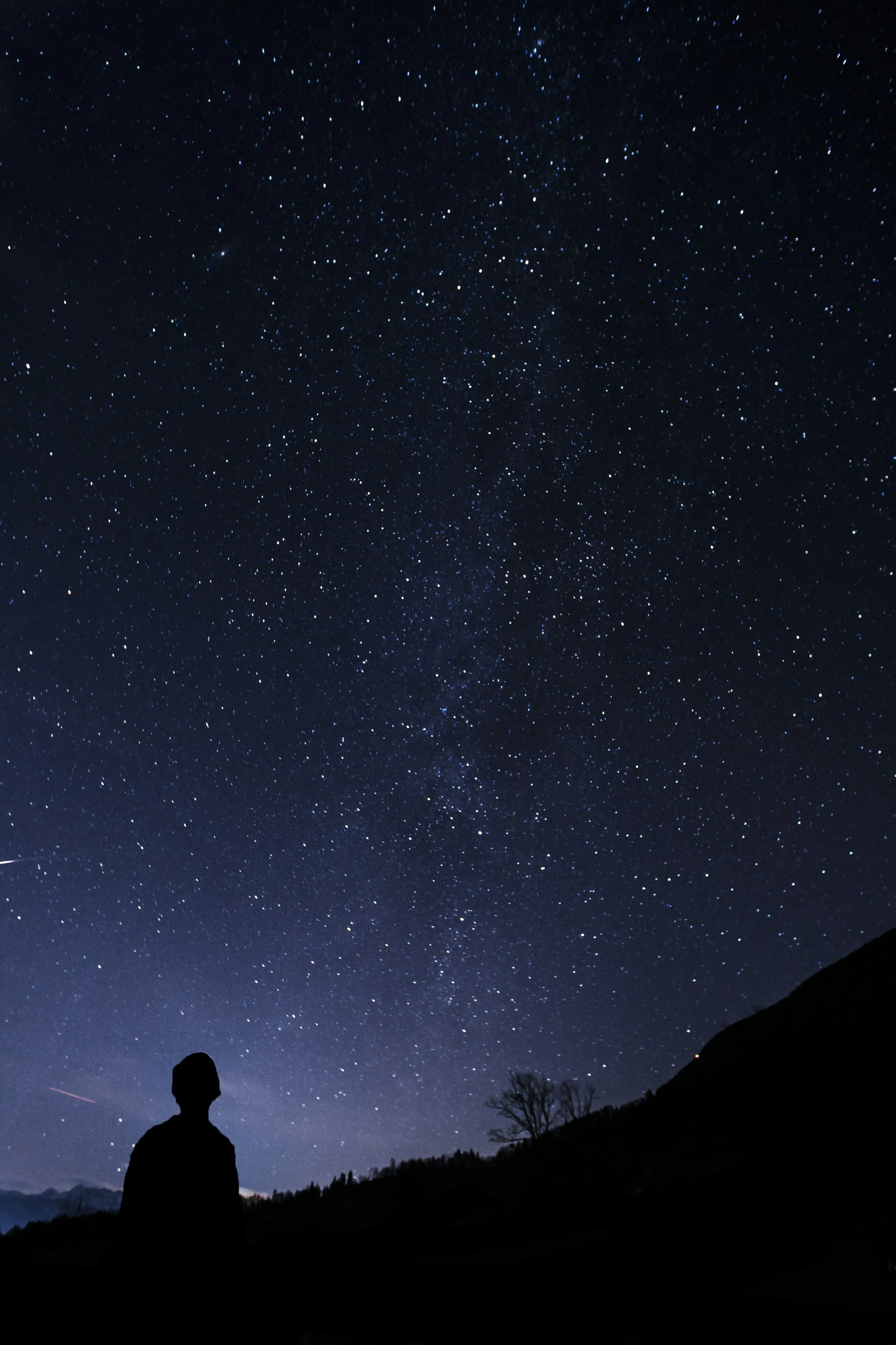 Person Standing Under Star Filled Night Sky Wallpaper