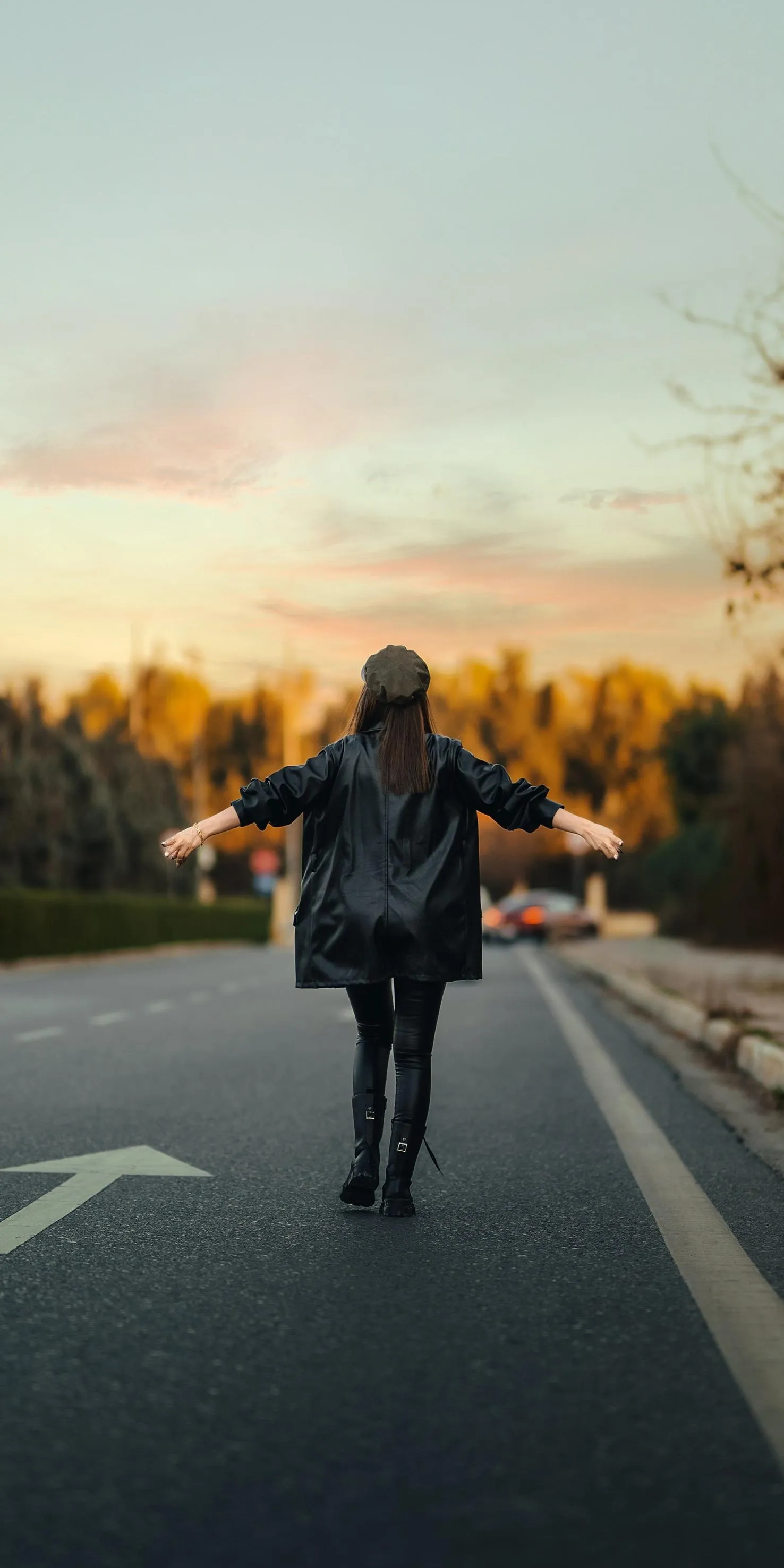 Person Walking on Road During Sunset with Calm Sky View