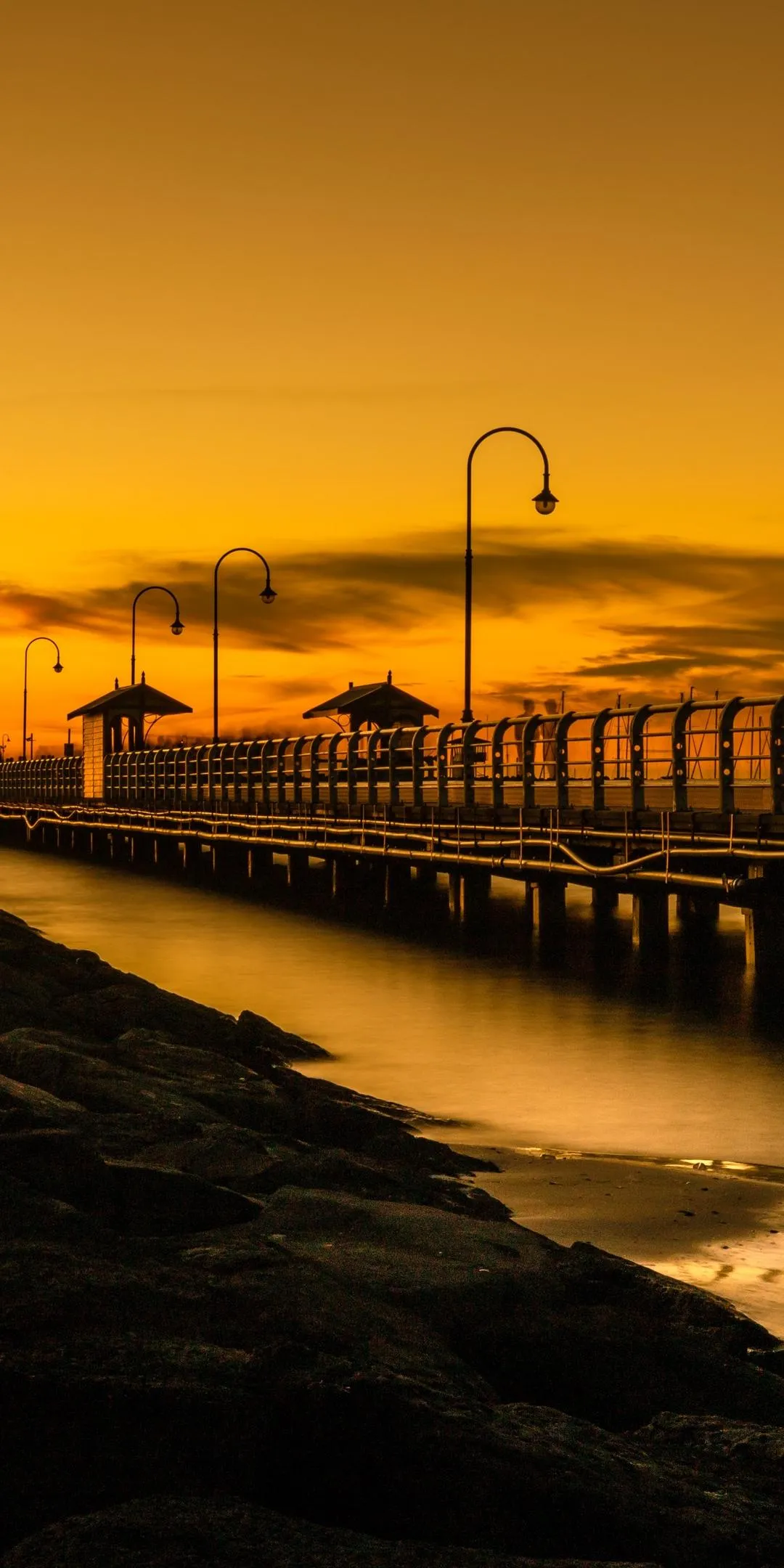 Pier Stretching into Ocean during Golden Hour Sunset