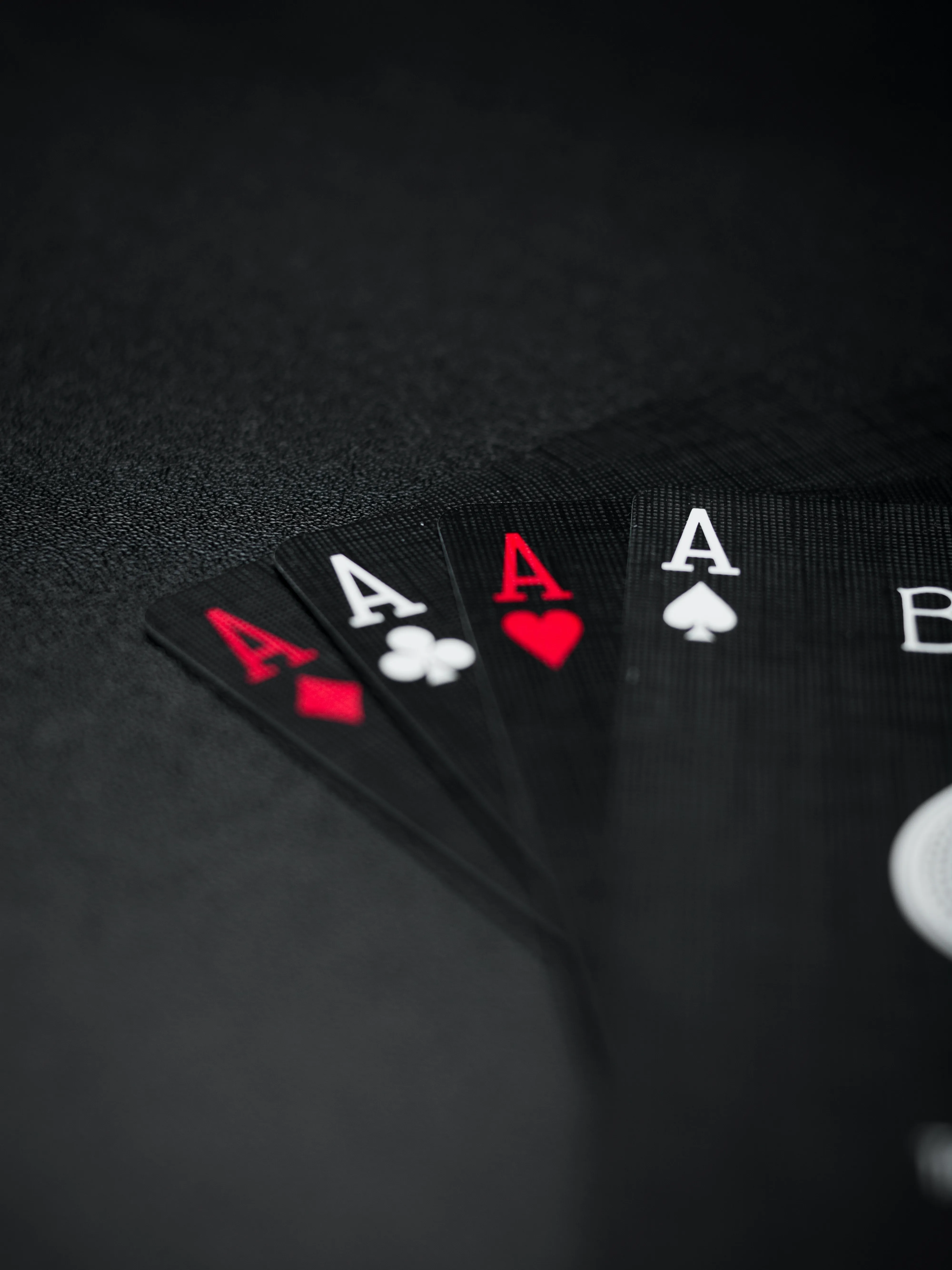 Poker Hand with Aces on Black Table Background Wallpaper