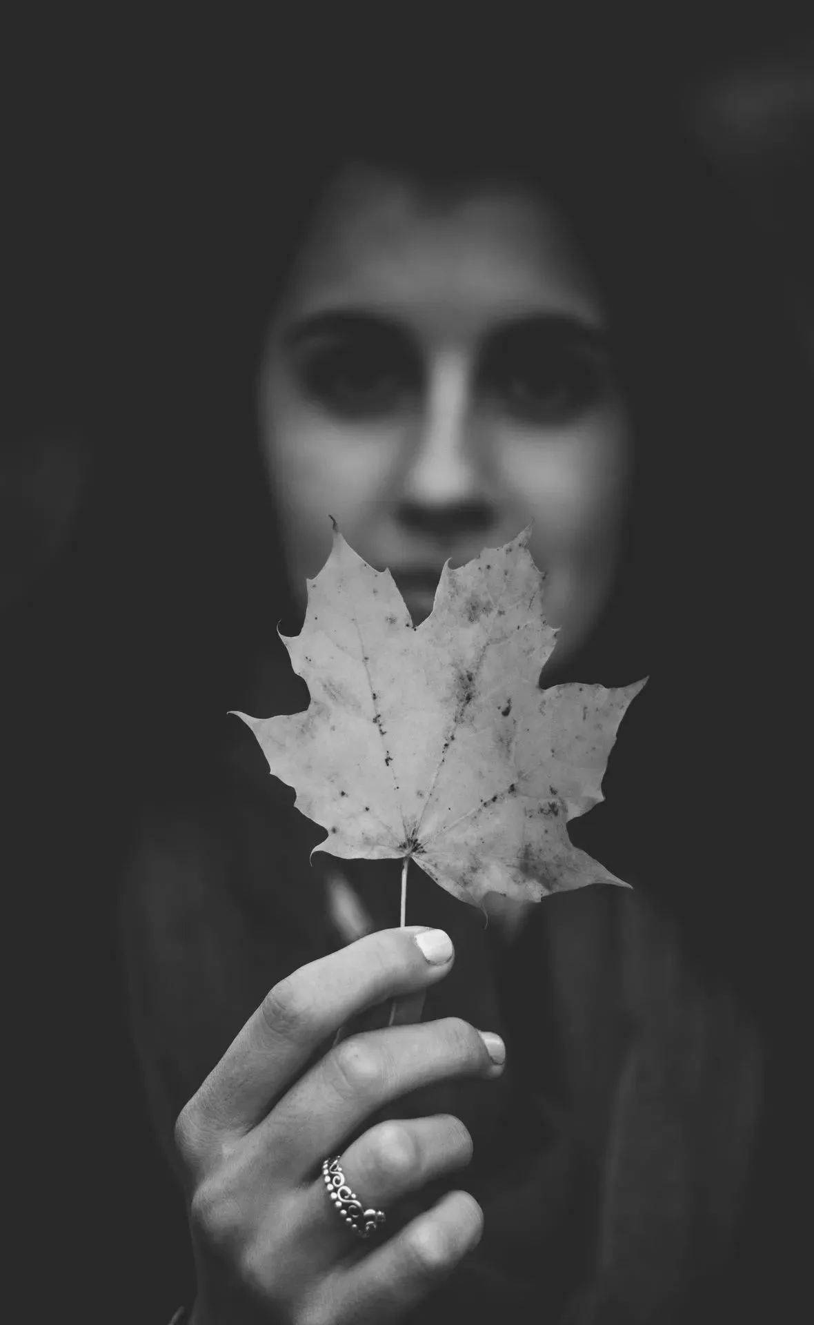 Portrait of Woman Holding Leaf in Soft Light Wallpaper