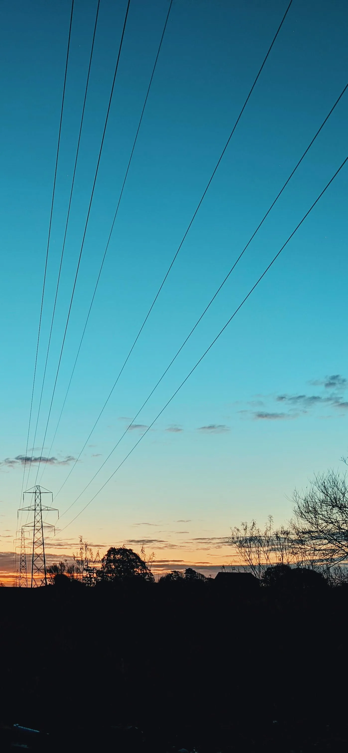 Power Lines Stretching Across a Sunset Colored Sky