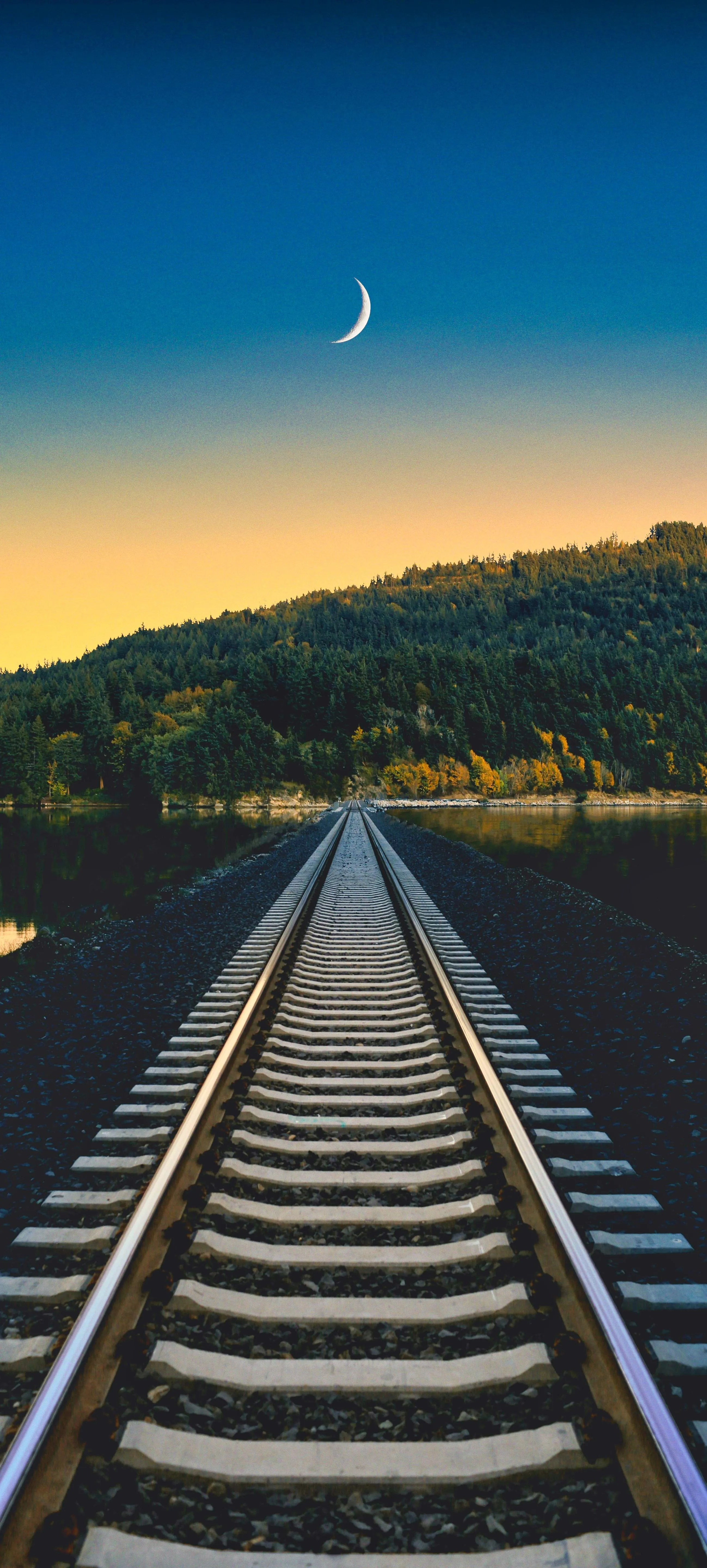 Railway Tracks Leading To Distant Hills Under Moon Image