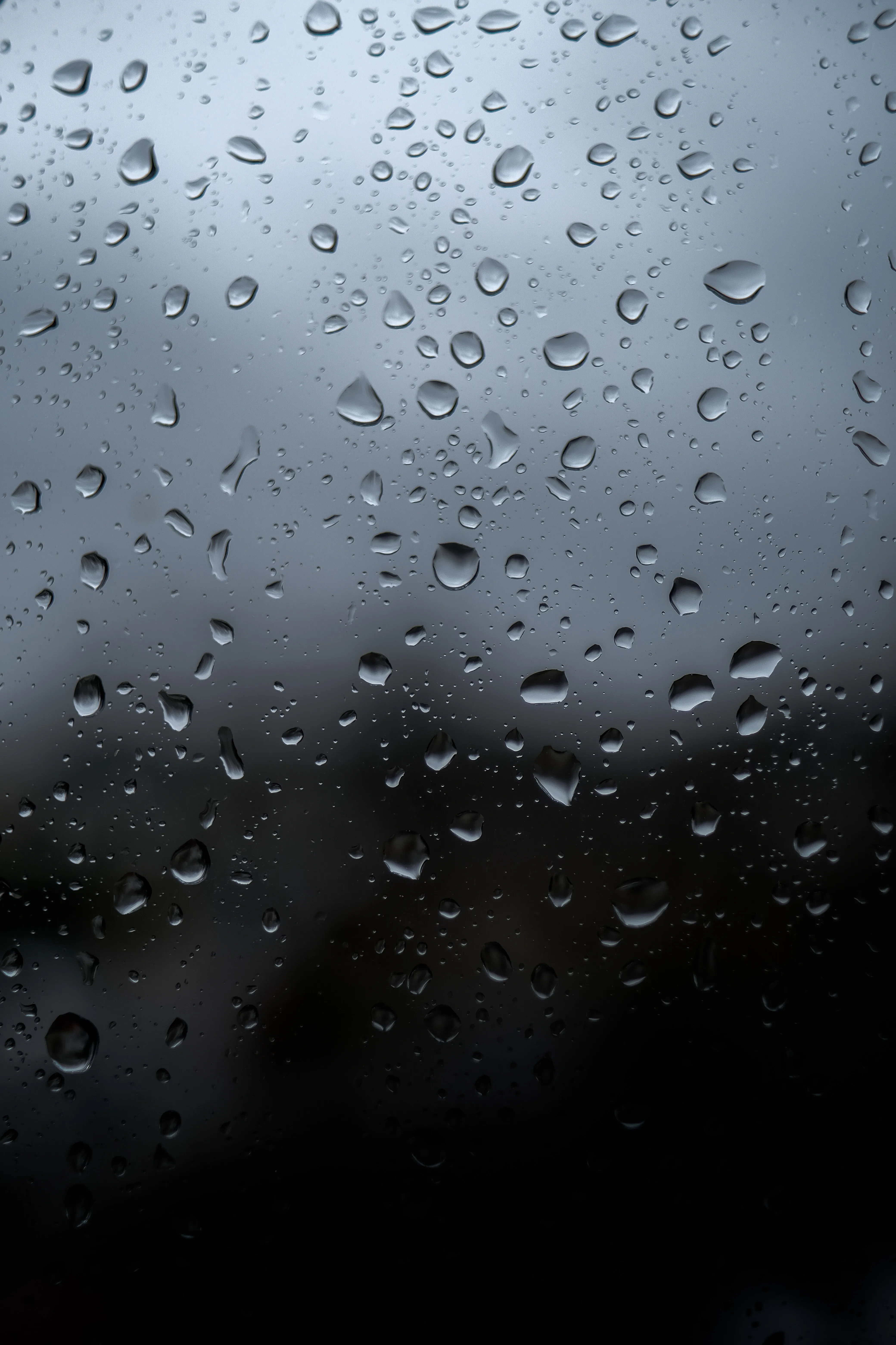 Raindrops on Glass Window Creating Soft Moody Look