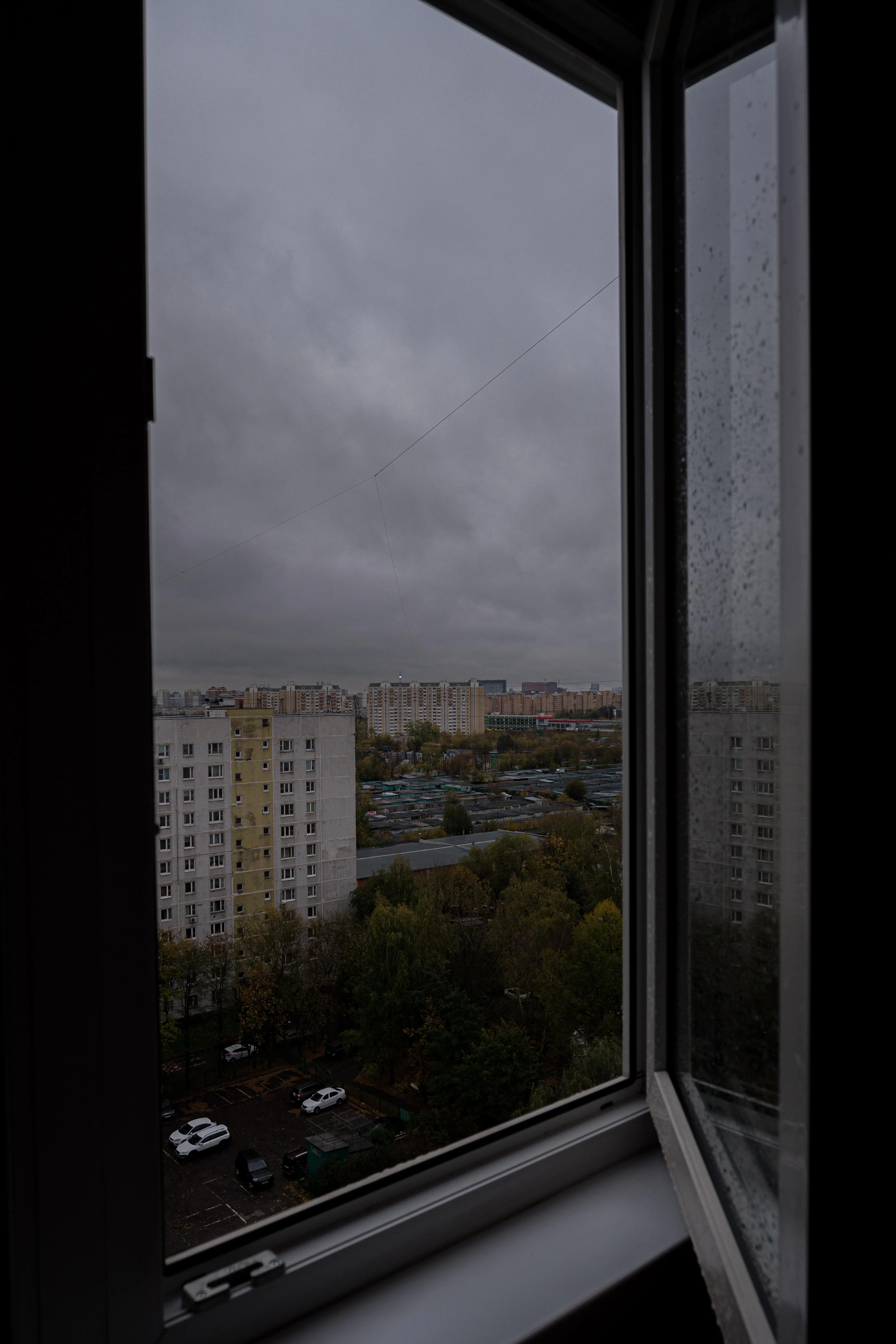 Rainy City View from an Open Window on a Cloudy Morning