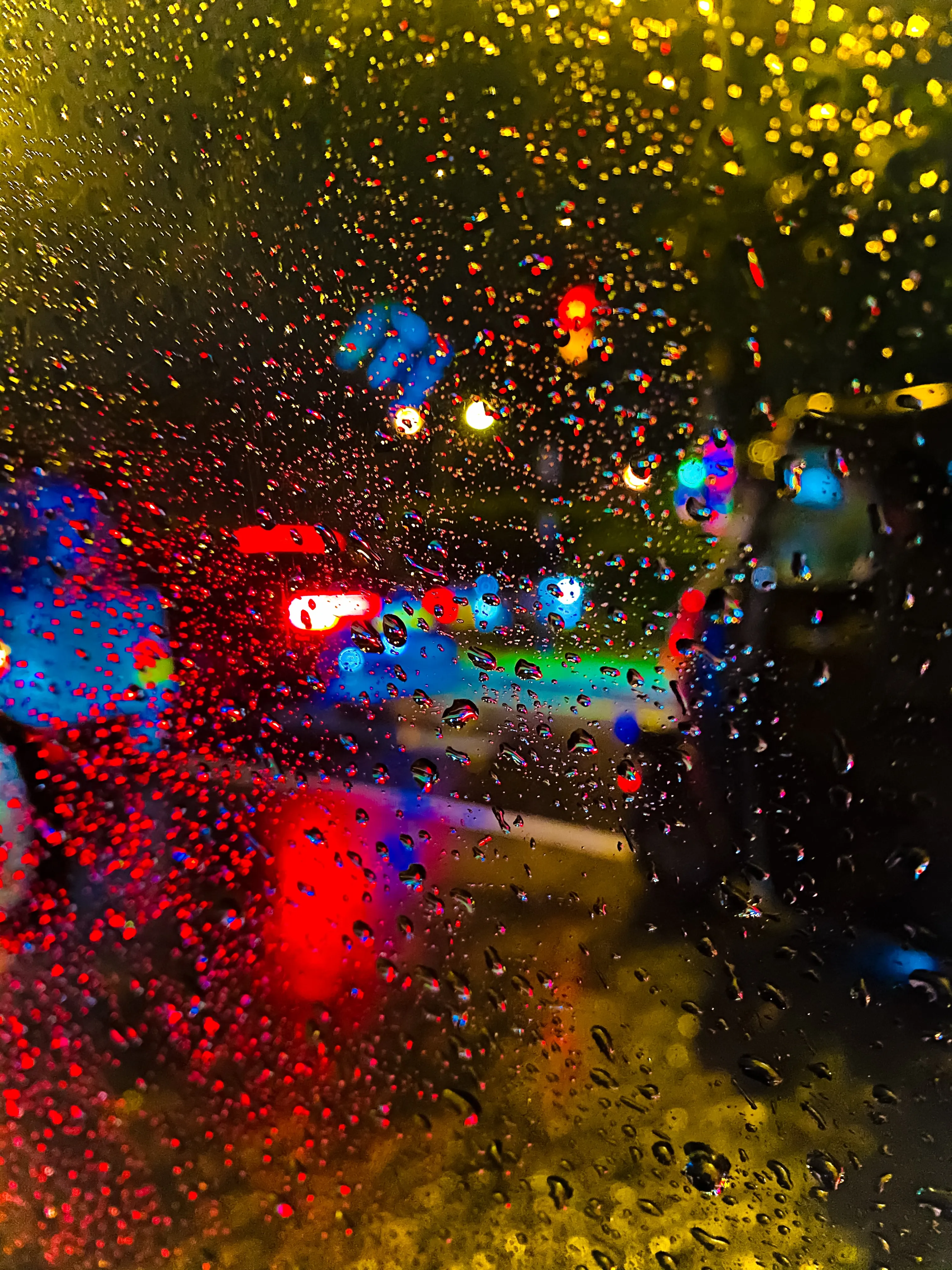 Rainy Night Lights Reflected on Wet Pavement Wallpaper
