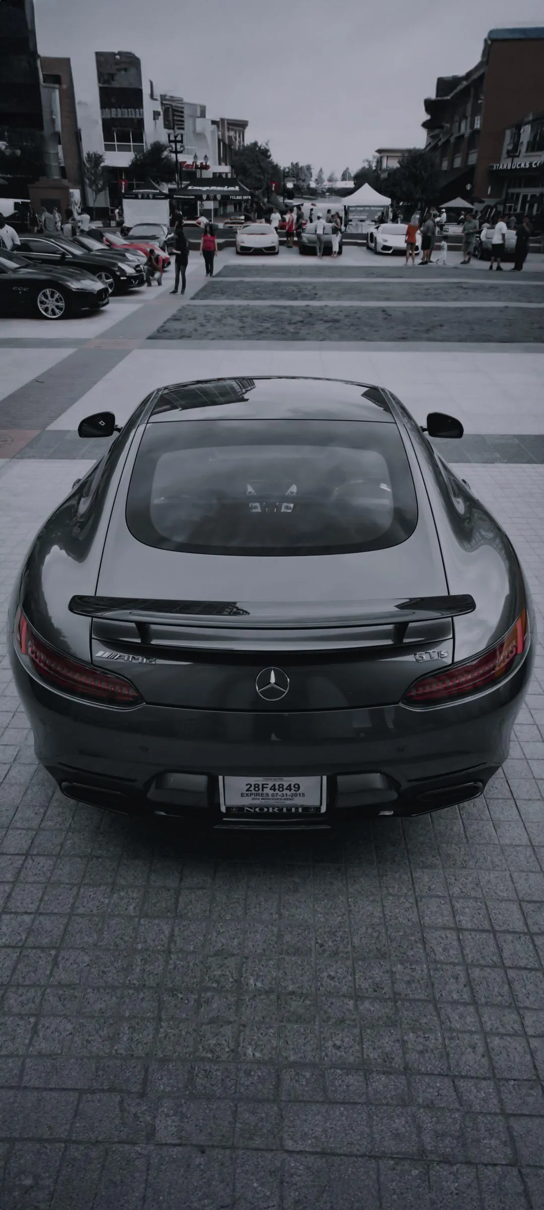 Rear View of Sports Car Driving Through City Street