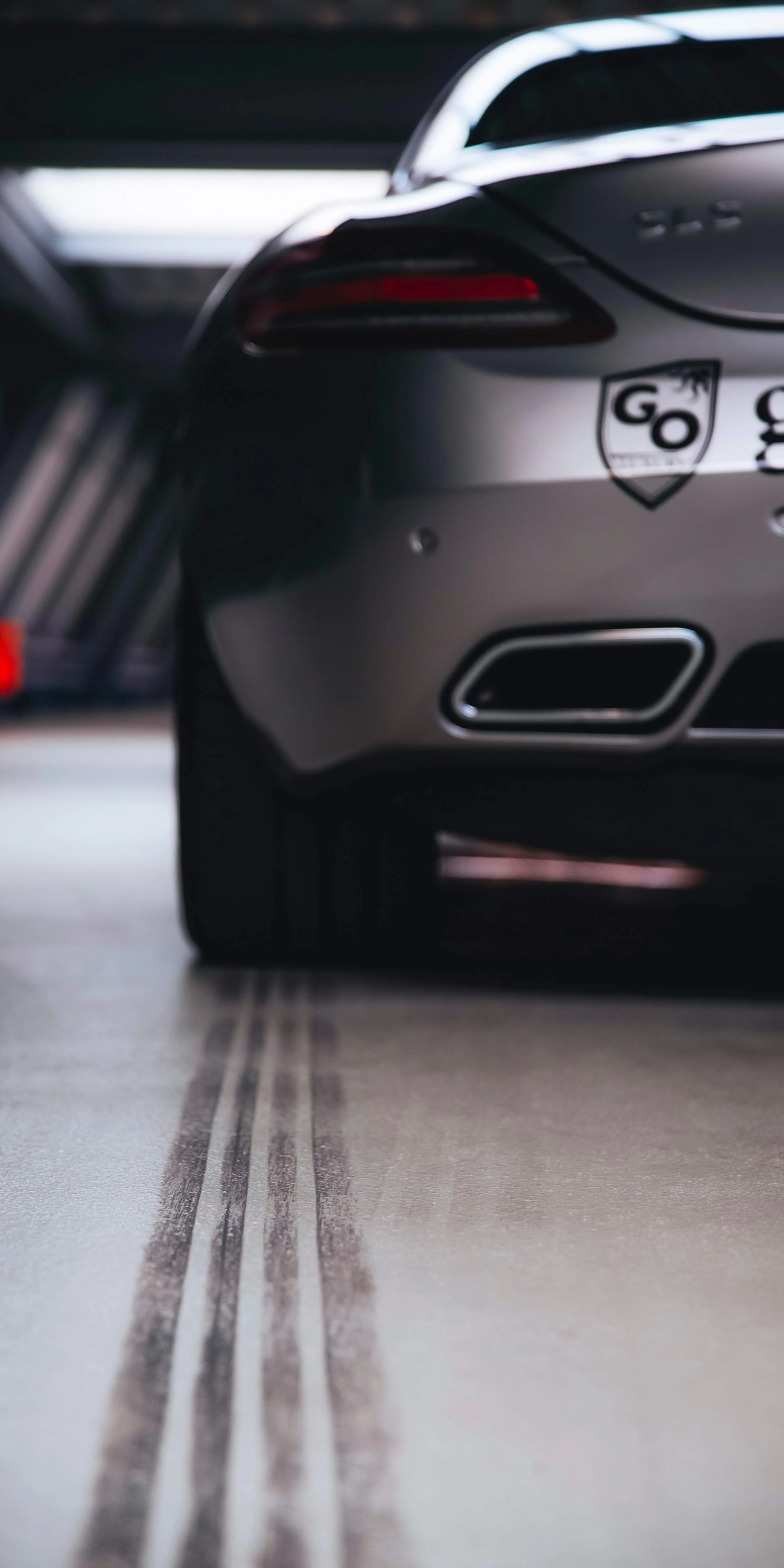 Rear View of Sports Car in Dramatic Lighting Wallpaper