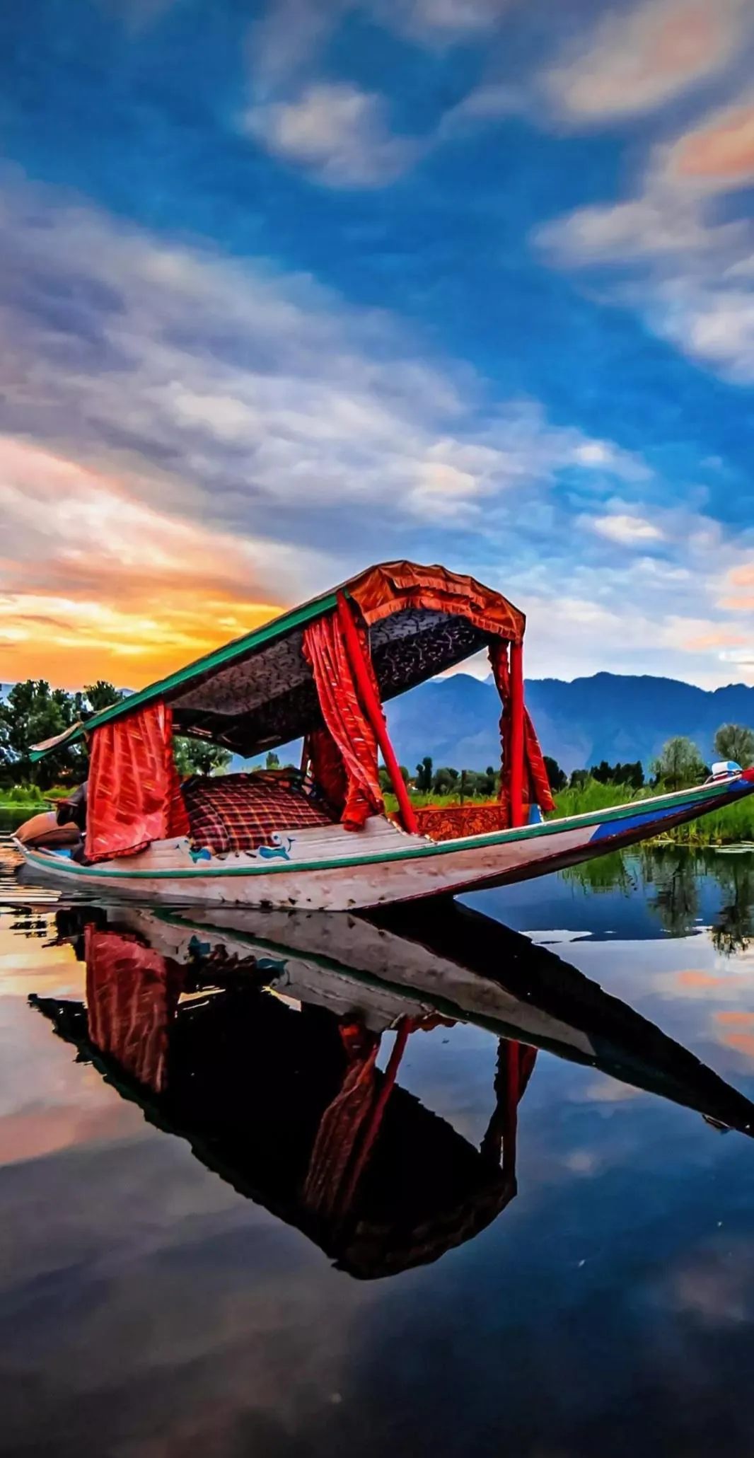 Red Boat Floating on Beach with Bright Blue Sky Wallpaper