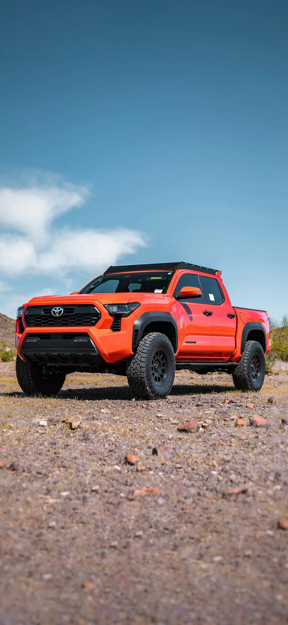 Red Off Road Vehicle on Rocky Desert Adventure Wallpaper