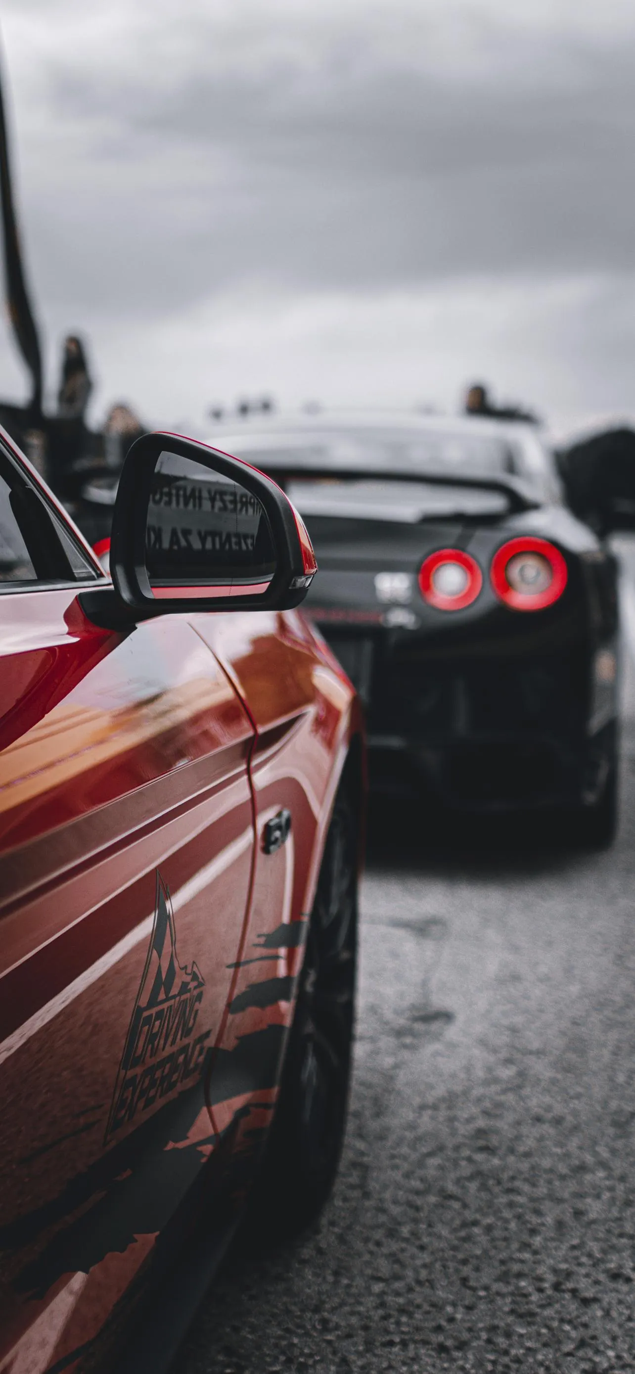 Red Sports Car Driving on Rainy City Street Surface