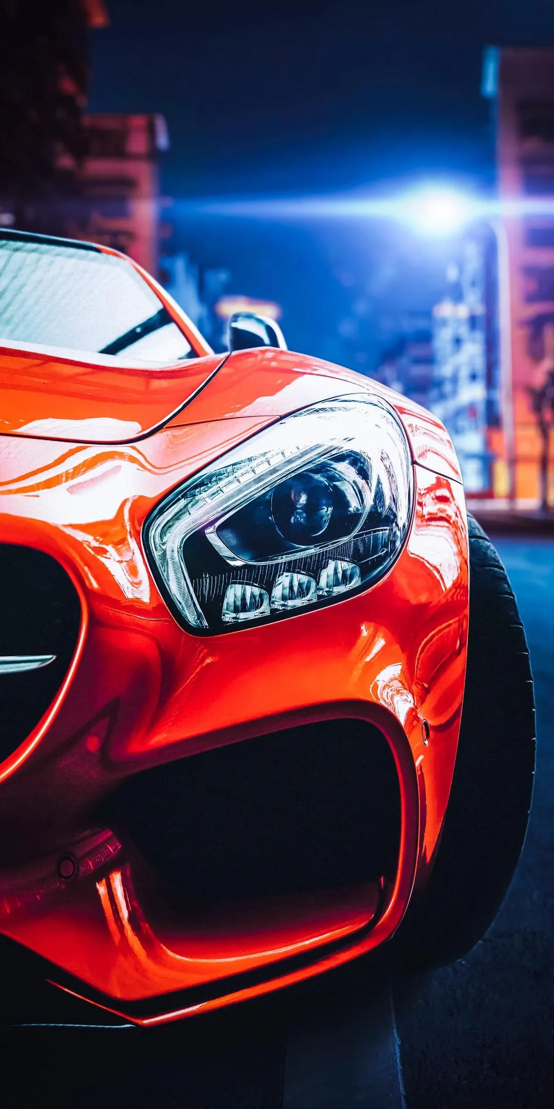 Red Sports Car Front Angle with Urban Lights Wallpaper