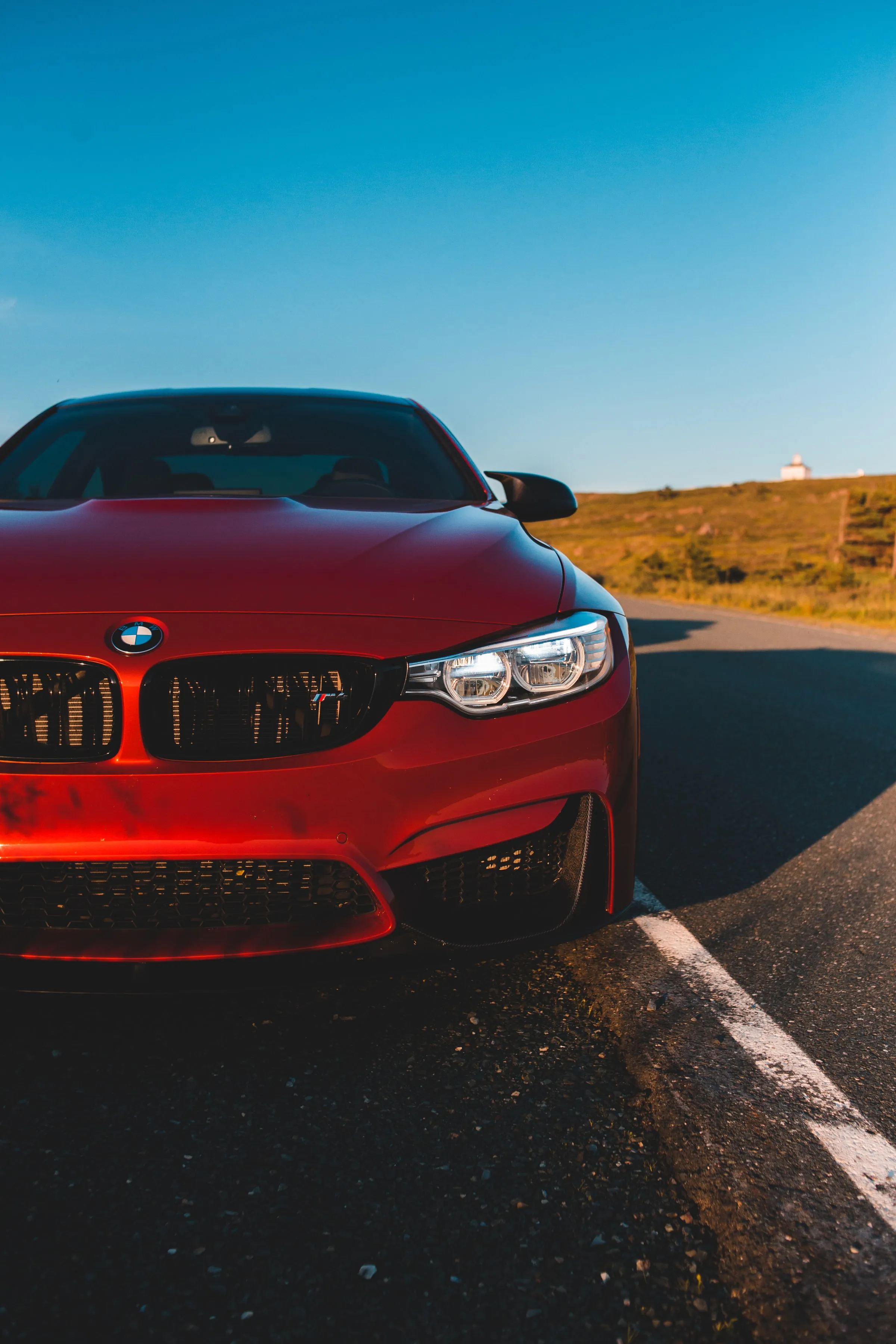 Red Sports Car on Open Road under Golden Sky Light Wallpaper