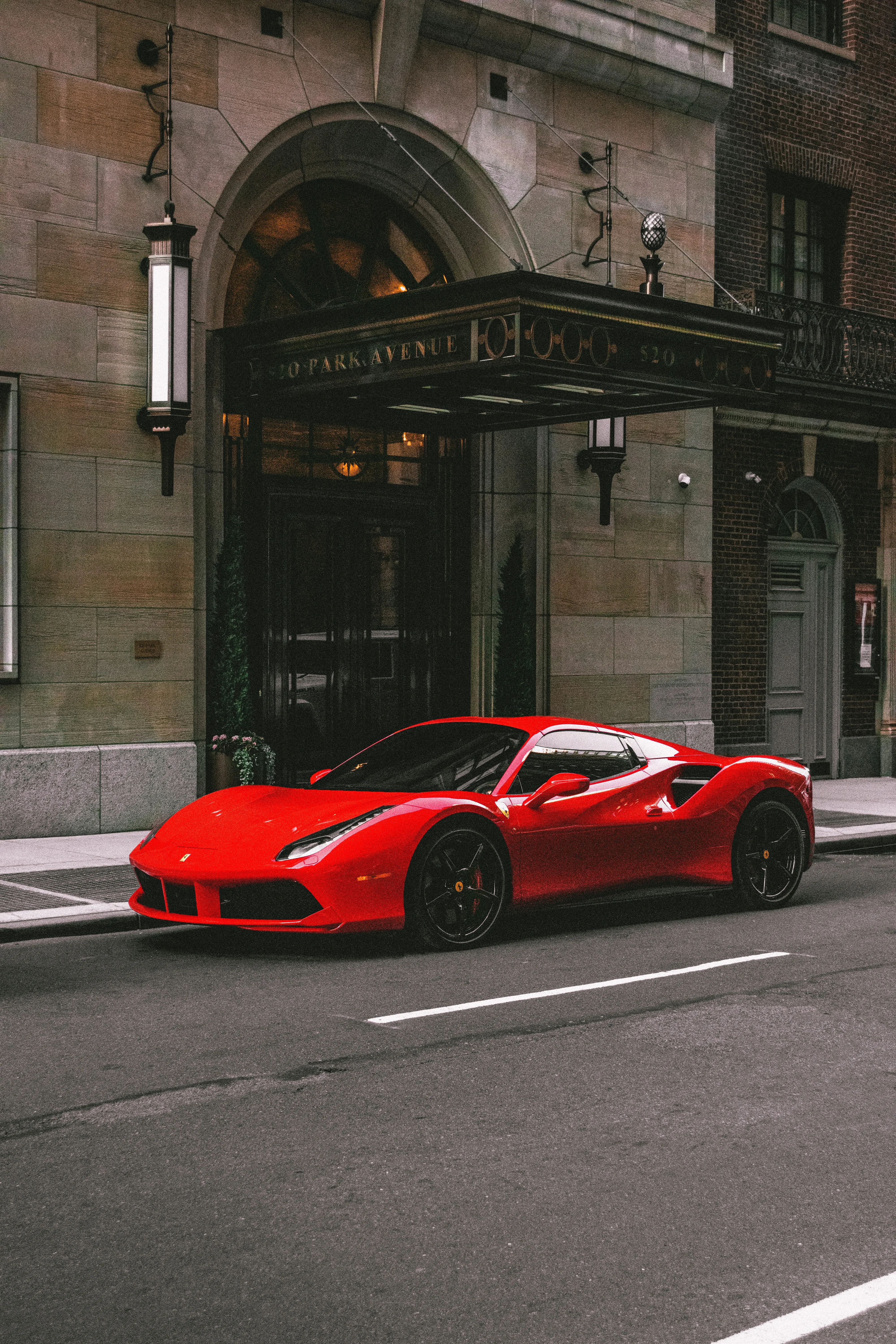 Red Sports Car Parked on Urban Street in Daylight Wallpaper