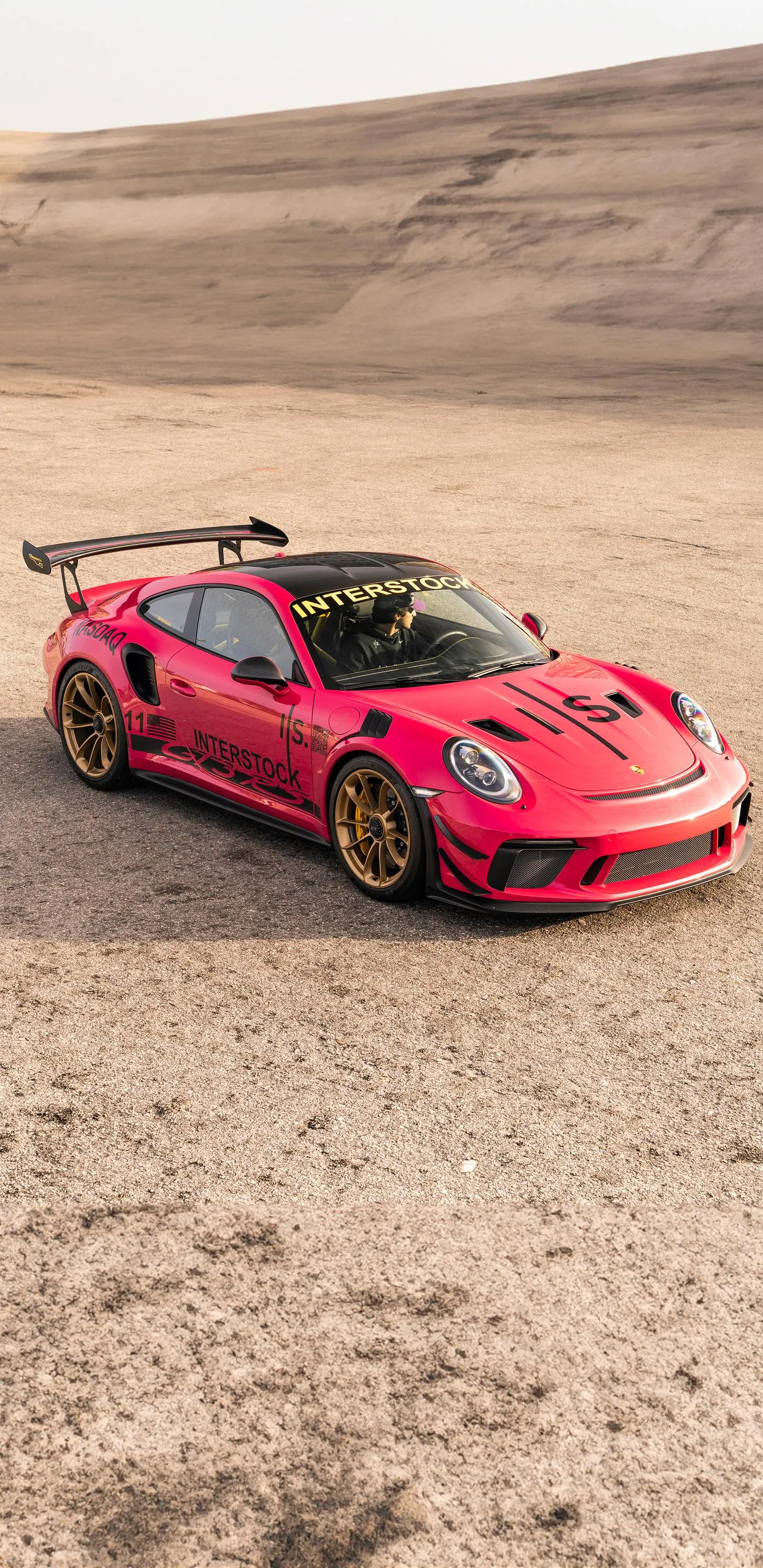 Red Sports Car Racing on Dusty Desert Terrain Wallpaper